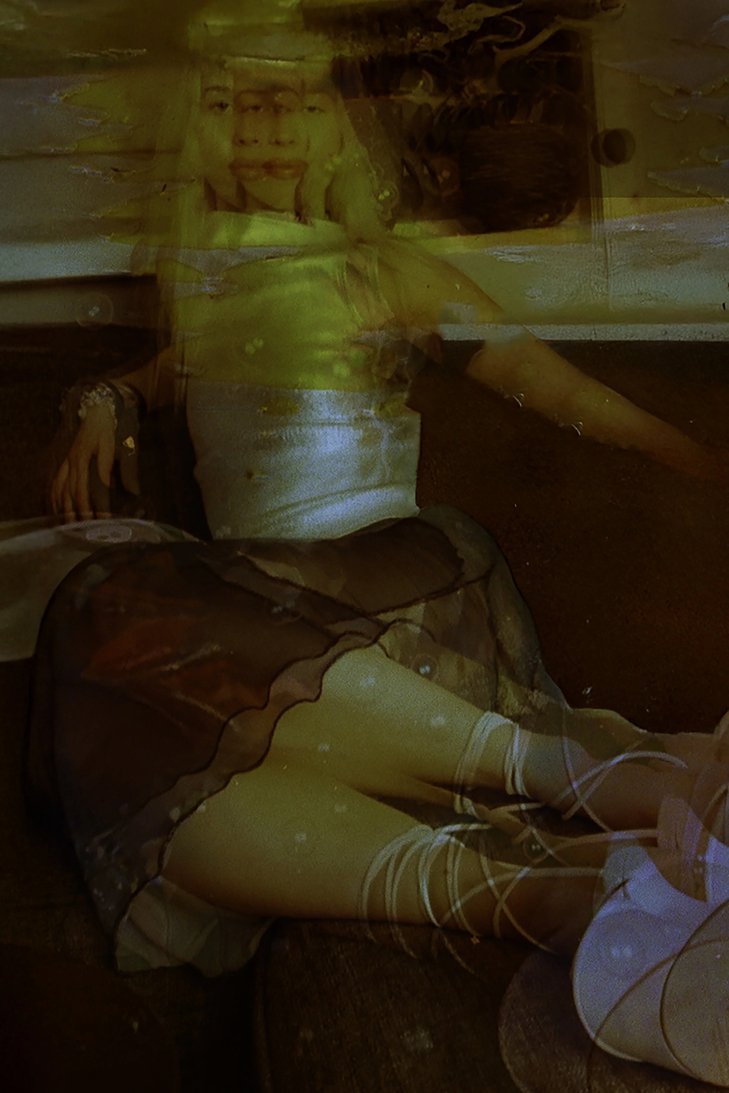Motion-blurred film image of legs in white socks and a long skirt, layered in green and red light. Bubblehead by Hartenjager.