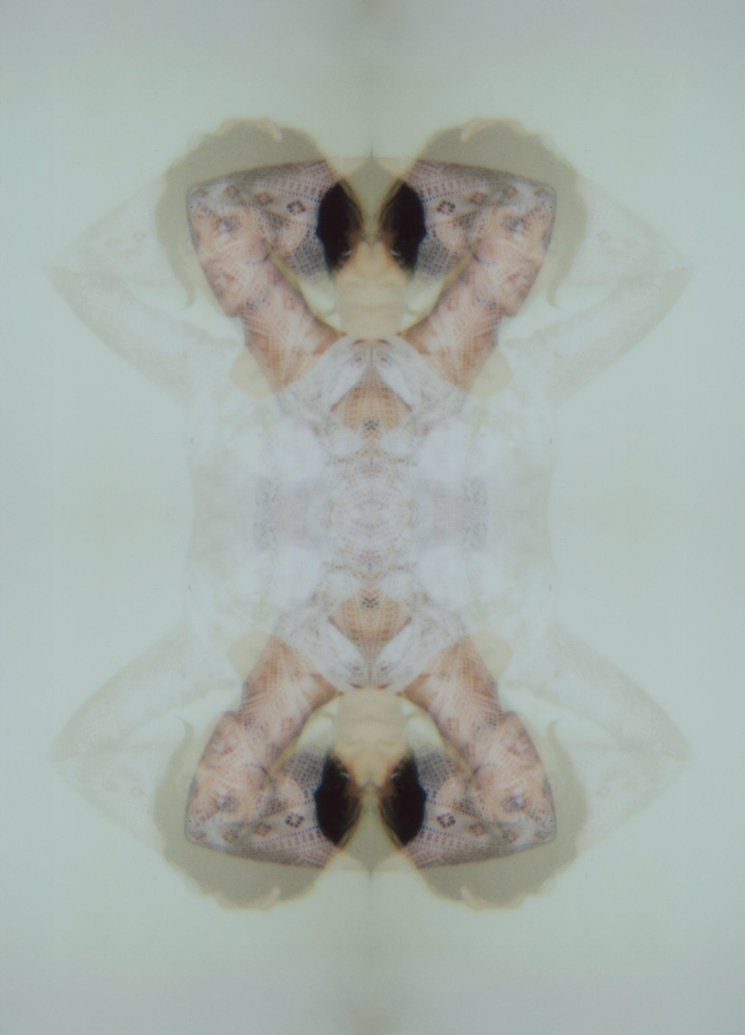 Mirrored, symmetrical Polaroid double exposure creating a butterfly-like pattern from a figure in lace. The Unveiled by Hartenjager.