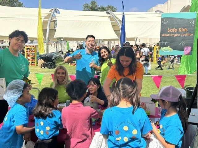 a group of adults showing something to a group of children