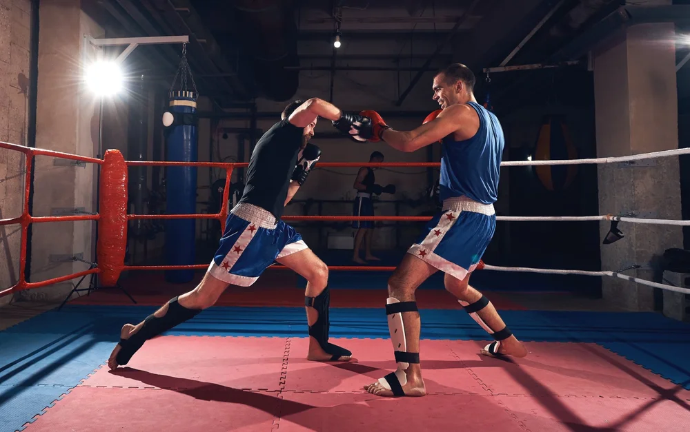 Two athletes practicing Muay Thai kickboxing