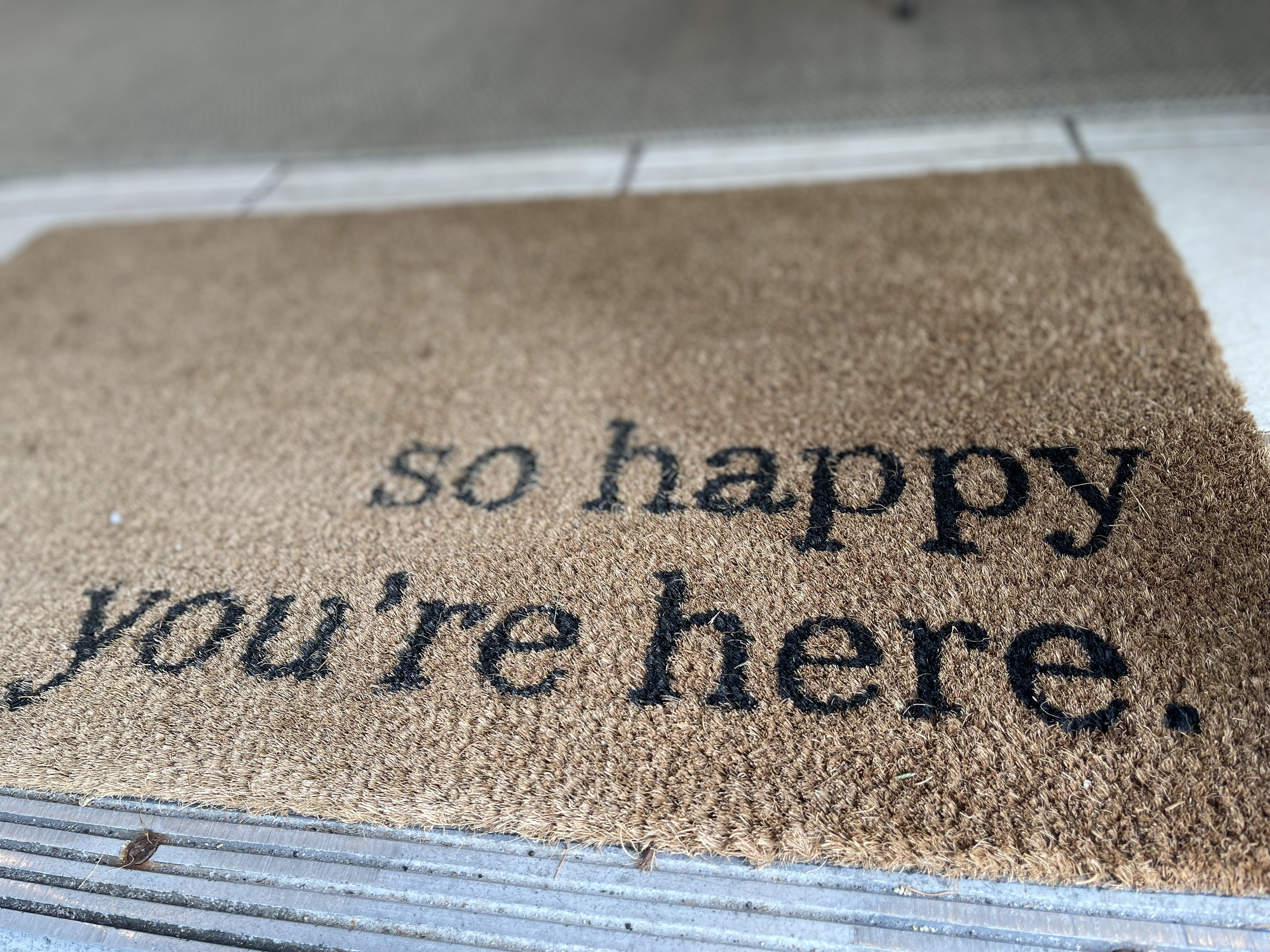doormat reading "so happy you're here" therapy Social Sparks RI