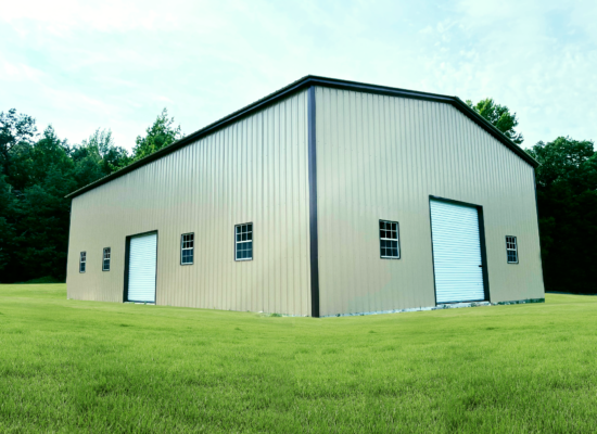 Large beige metal storage building with two garage doors and small windows, situated on a green grassy field.