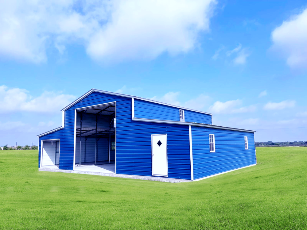 Blue metal barn with an open section and a white door, situated on a green grassy field under a partly cloudy sky.