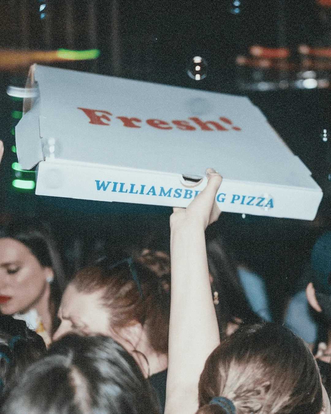Matinee holding up a pizza box