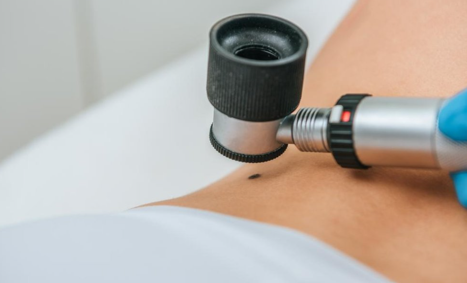 Close-up of a medical professional using an ultrasound device on a patient's abdomen.