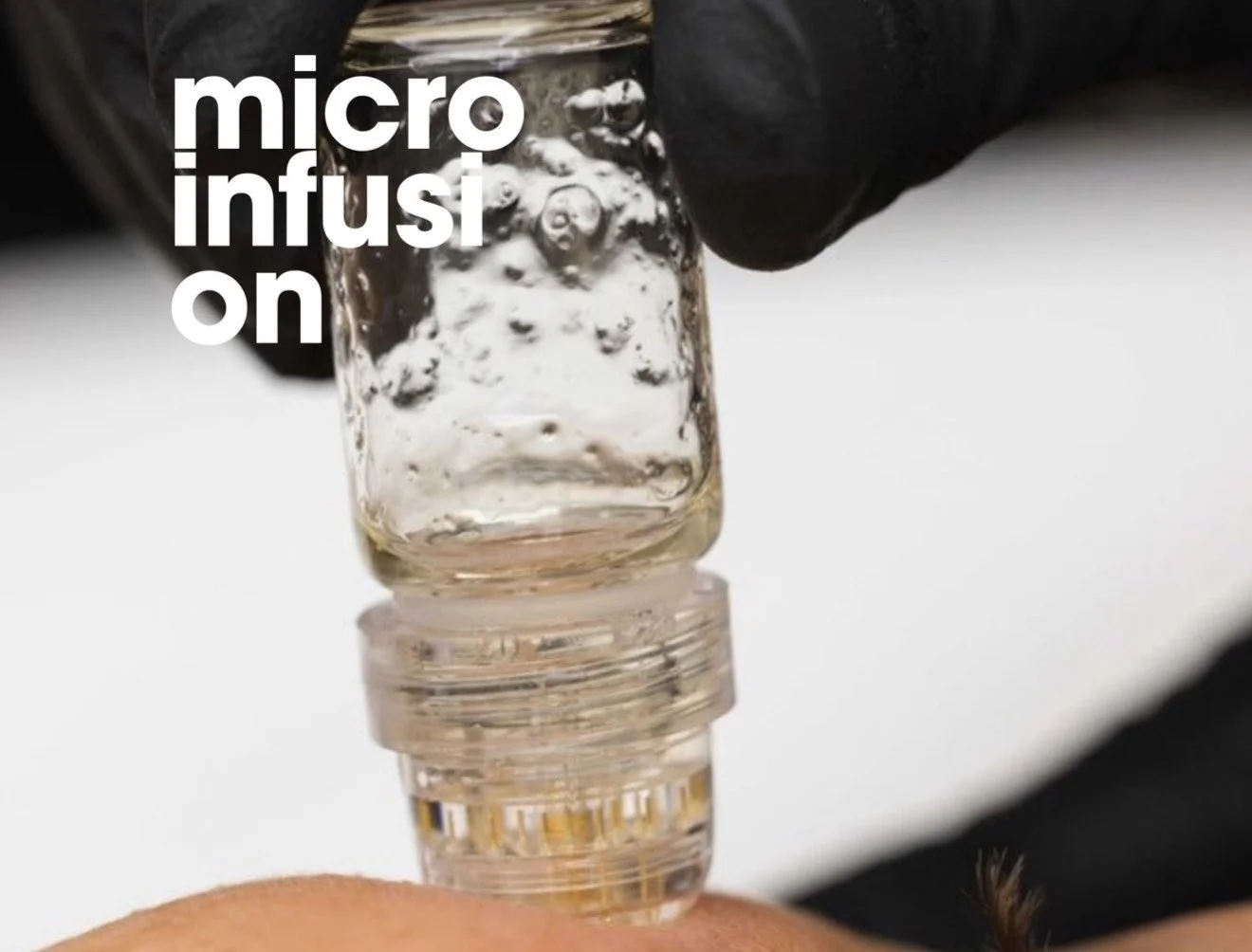 Close-up of a glass vial being filled with liquid from a syringe, with text overlay reading 'micro infusion'.