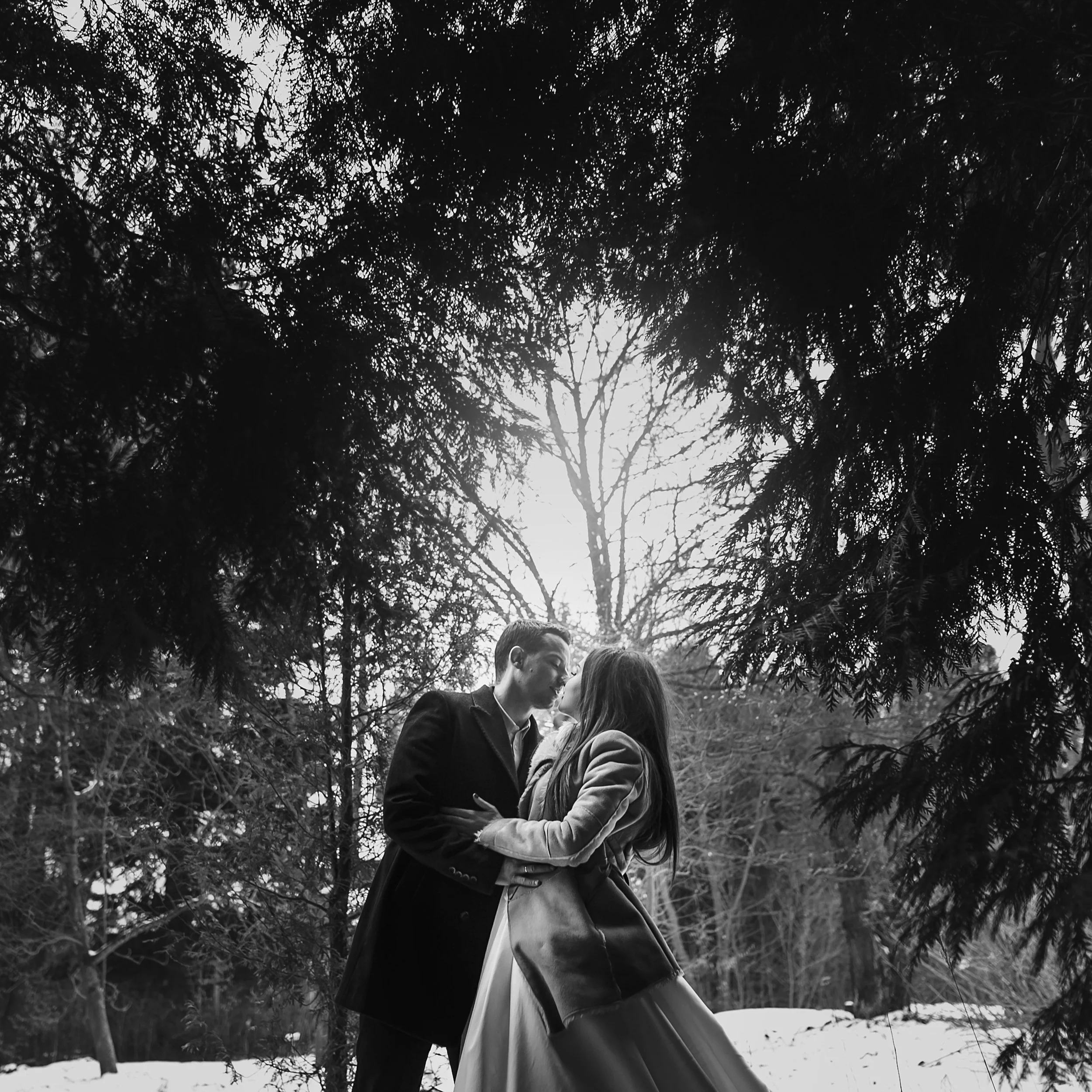 stylish-bride-in-coat-and-groom-embracing-under-g-2023-11-27-04-59-44-utc.JPG