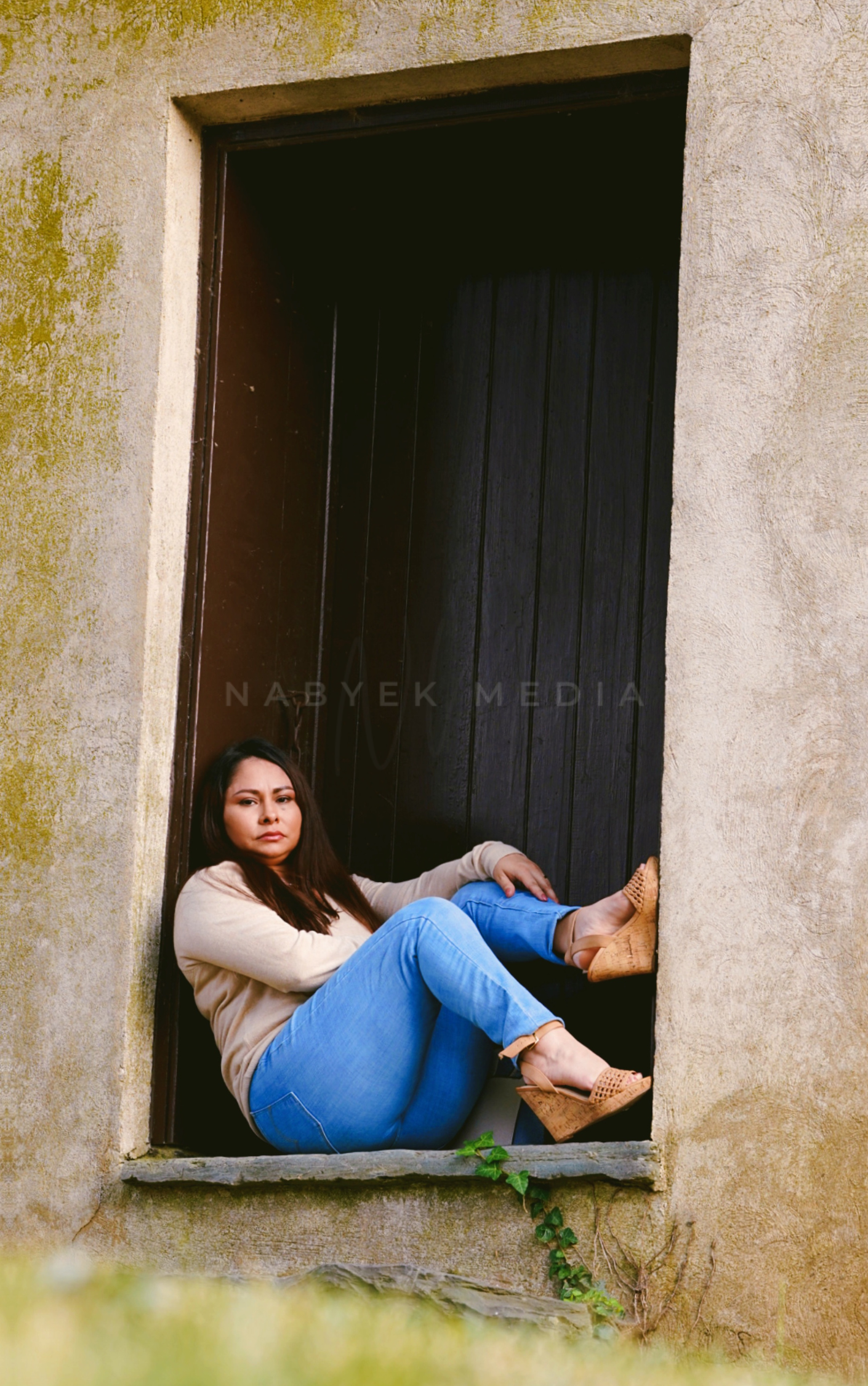 women posing sitting in front of door