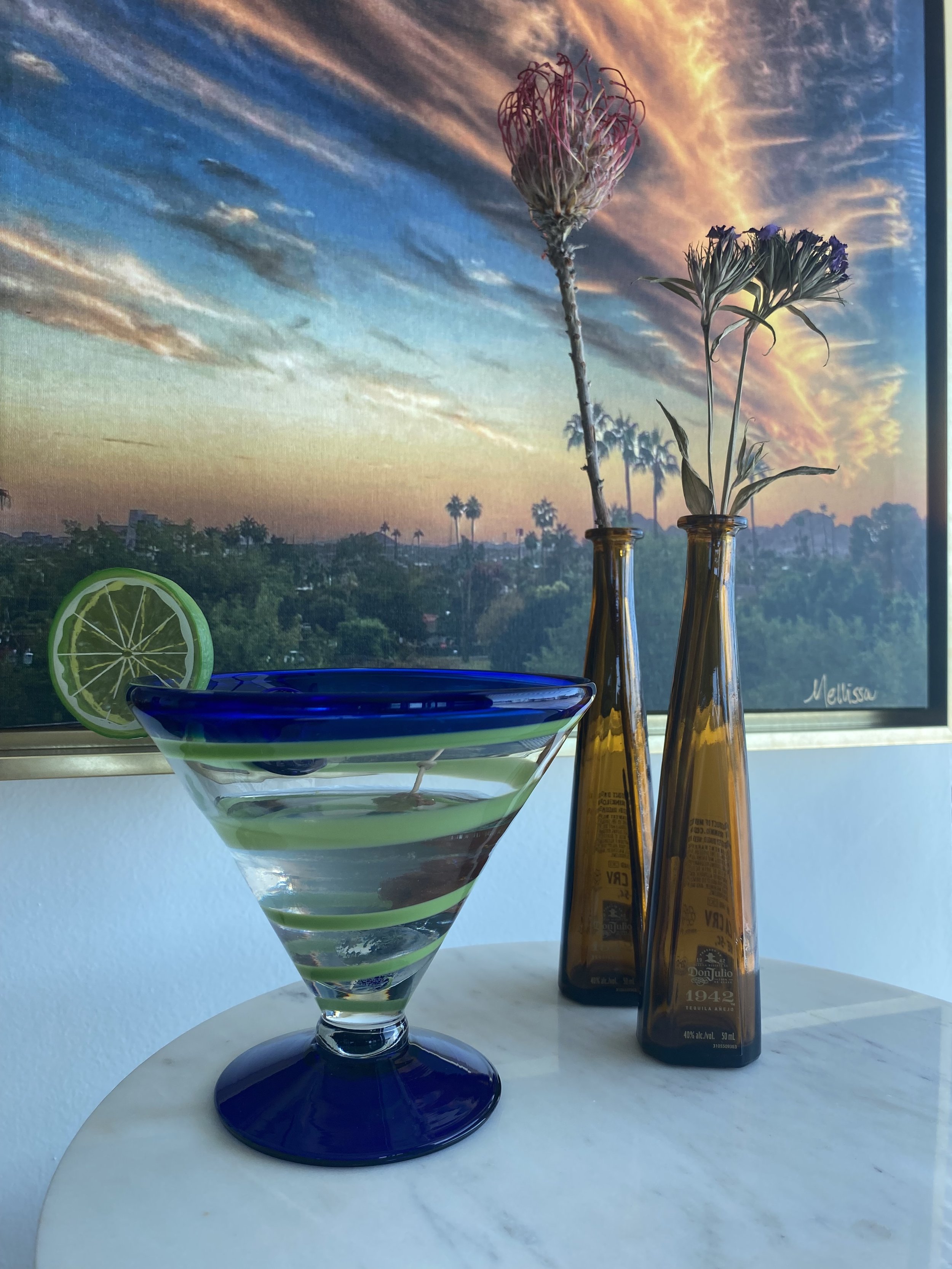 Blue marg with tequila bottles and flowers.jpeg