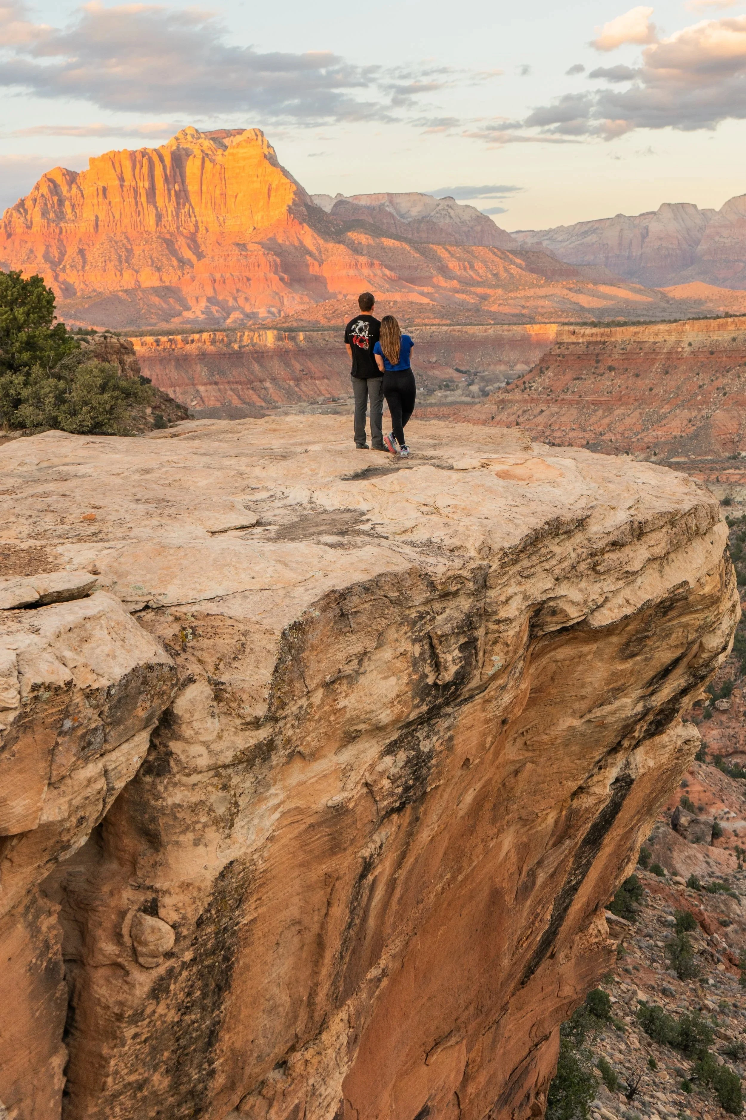 A couple takes in the sunset views of Zion National Park, Utah.