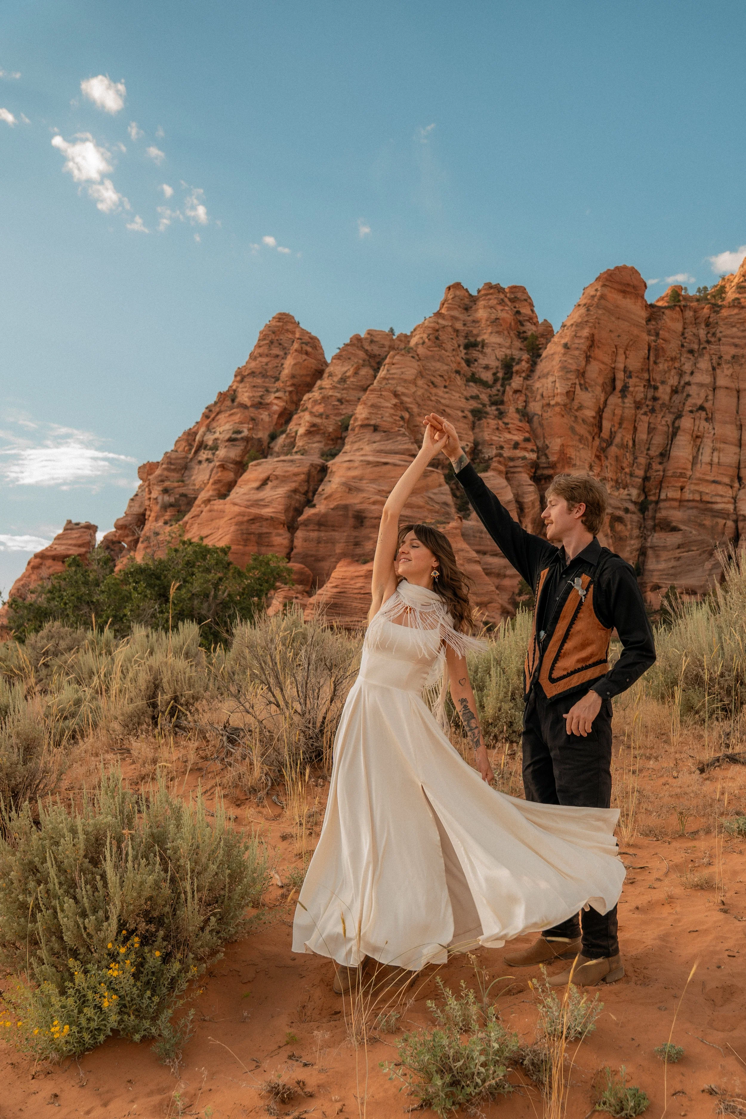 A couple dances in a beautiful desert landscape in Zion National Park, Utah.