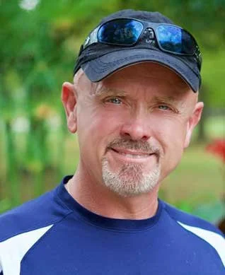 Portrait of Michael Wadkins, USPA Board Member and founder of Xcel Skydiving, whose decades of civilian and military skydiving experience set the tone for Skydive Skydown’s coach course.