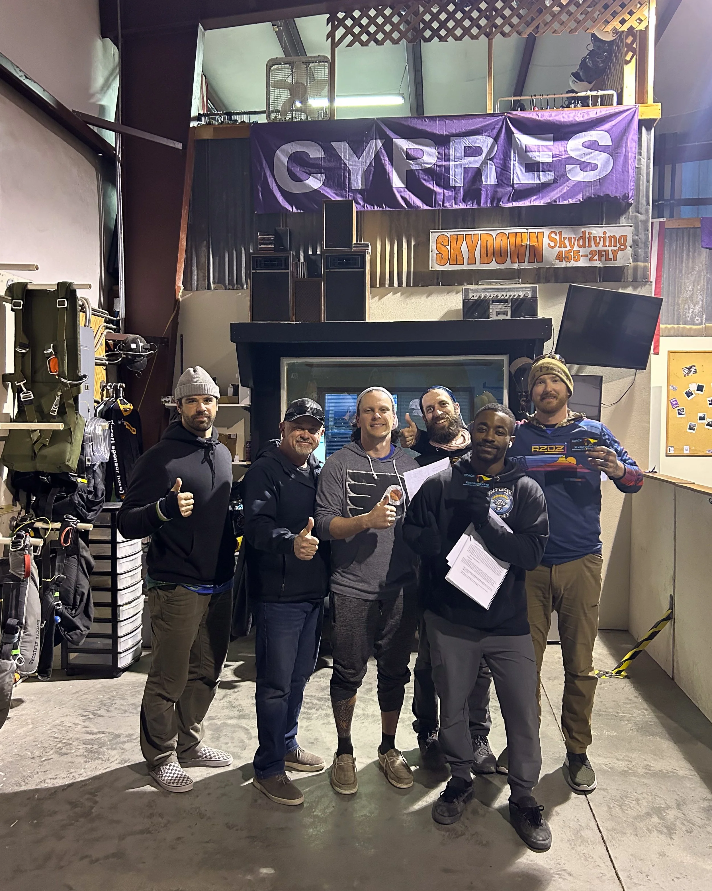 Group photo of the passing coach candidates at Skydive Skydown alongside instructor Michael Wadkins and DZO Jordon Basurto.