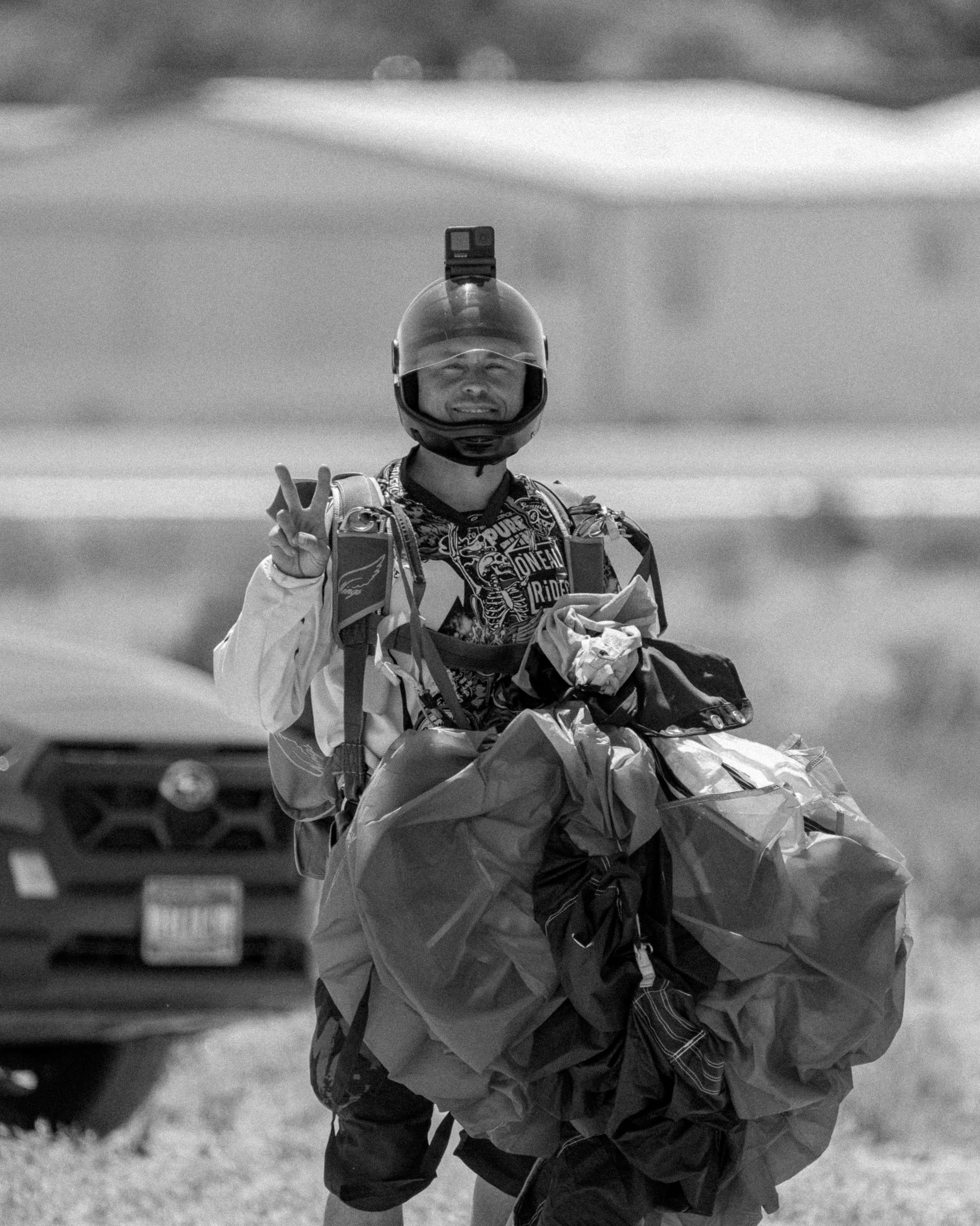 Brandon Dumont giving a thumbs up to the camera while walking back in after a skydive at Skydive Skydown.