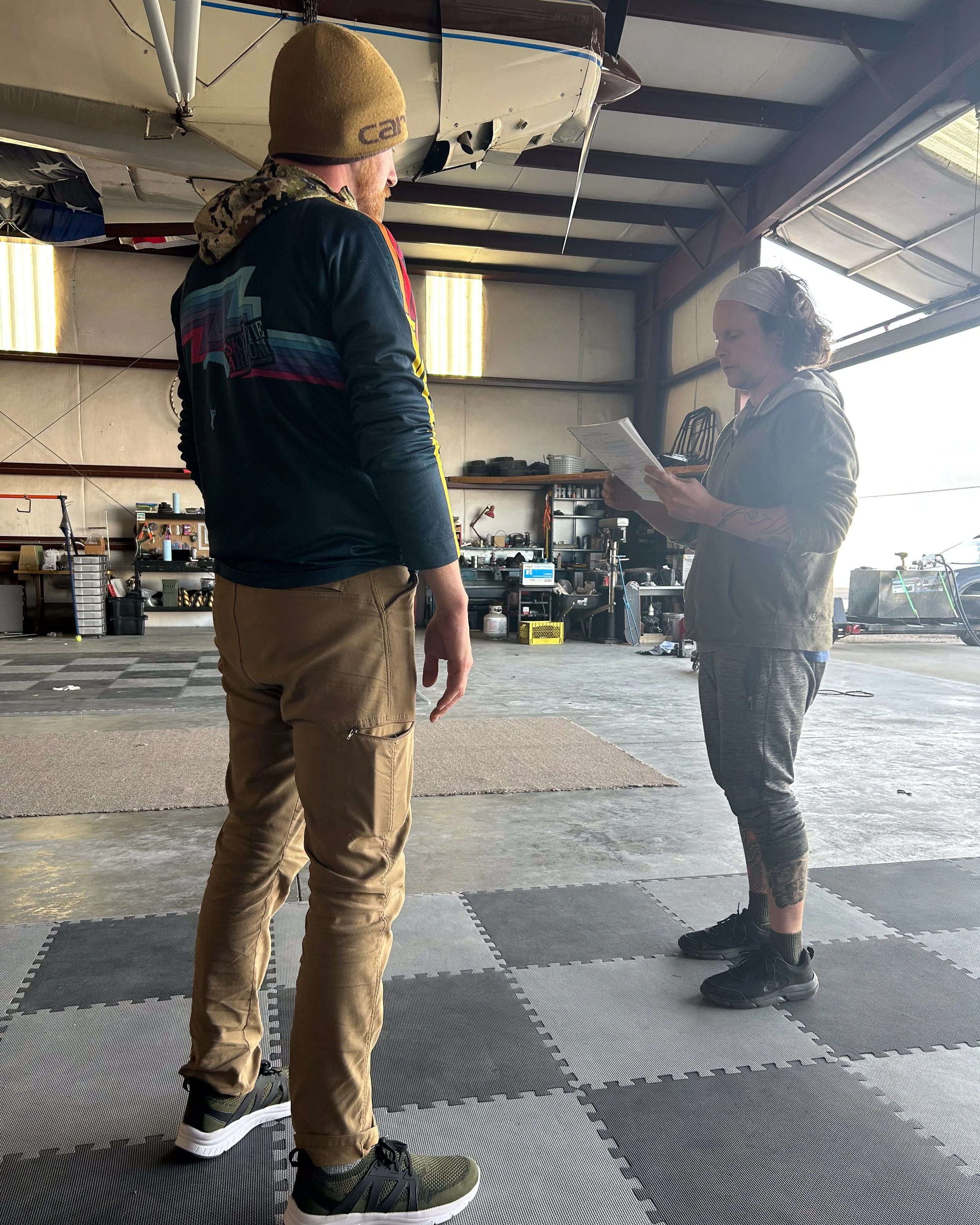 Coach candidates Rich Tralewski and Mason Orme practicing training drills together during the Skydive Skydown coach course.