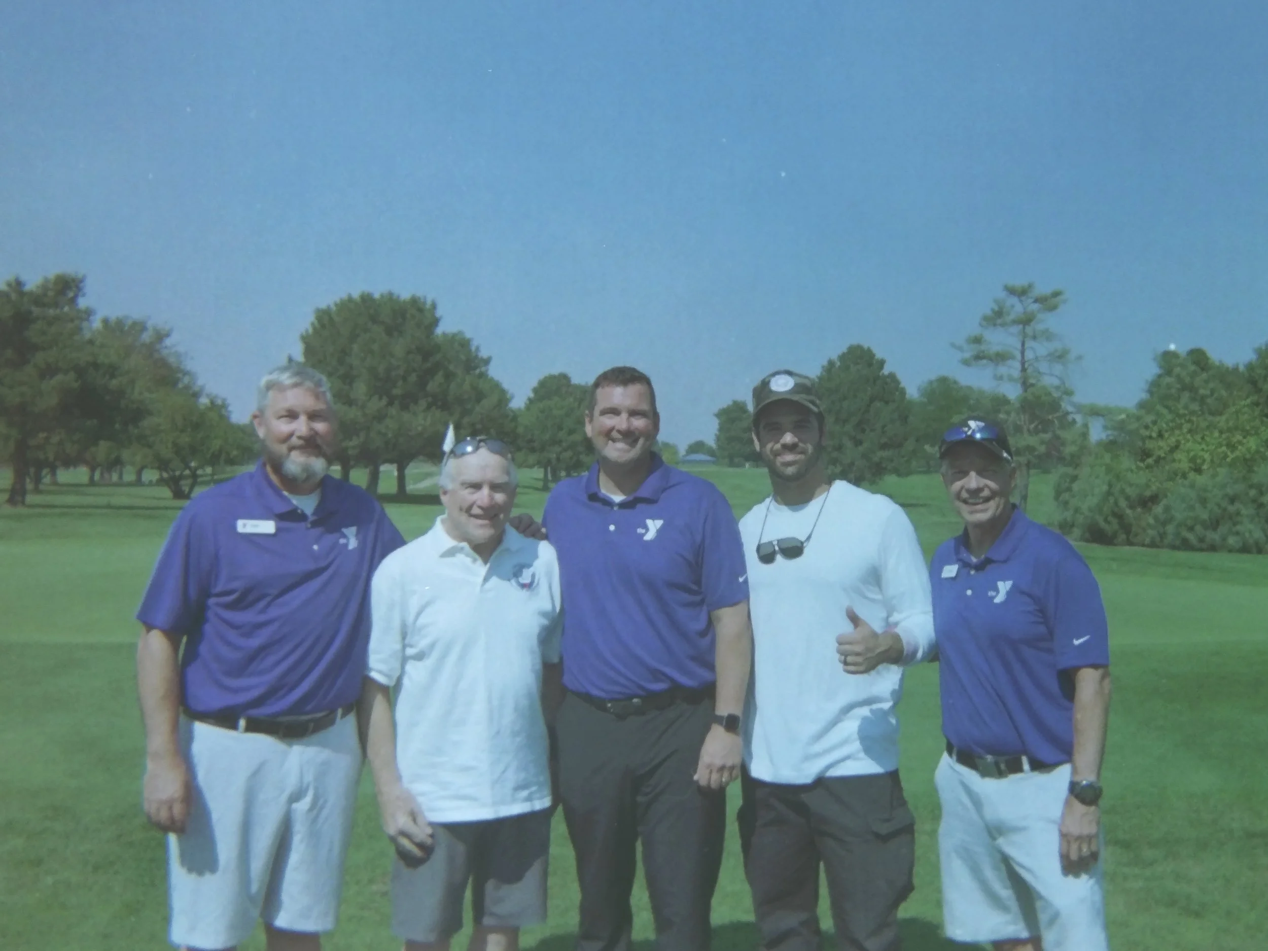 Skydive Skydown demo team members Rob Herndon and Jordon Basurto with the Caldwell Mayor and YMCA event staff at a community skydiving demonstration at Purple Sage golf course.