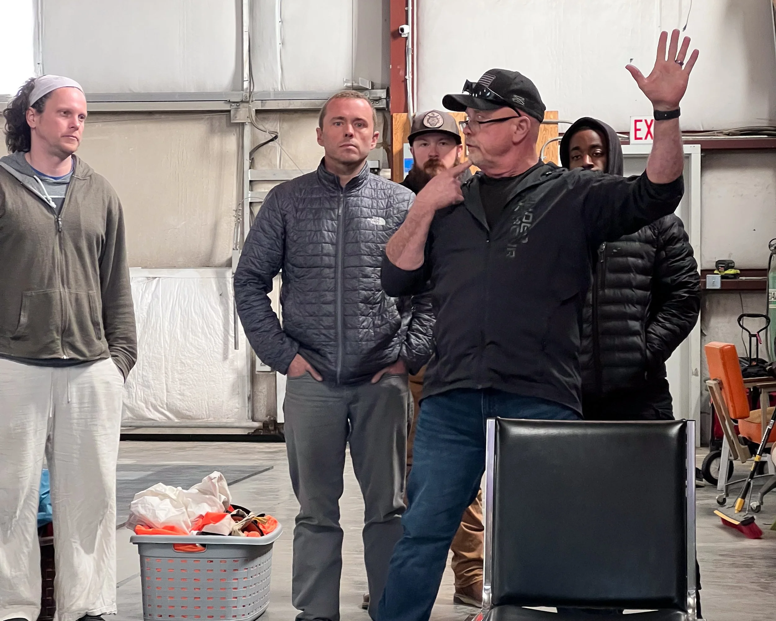 Michael Wadkins running an instructional demonstration as coach candidates follow along in the background at Skydive Skydown.
