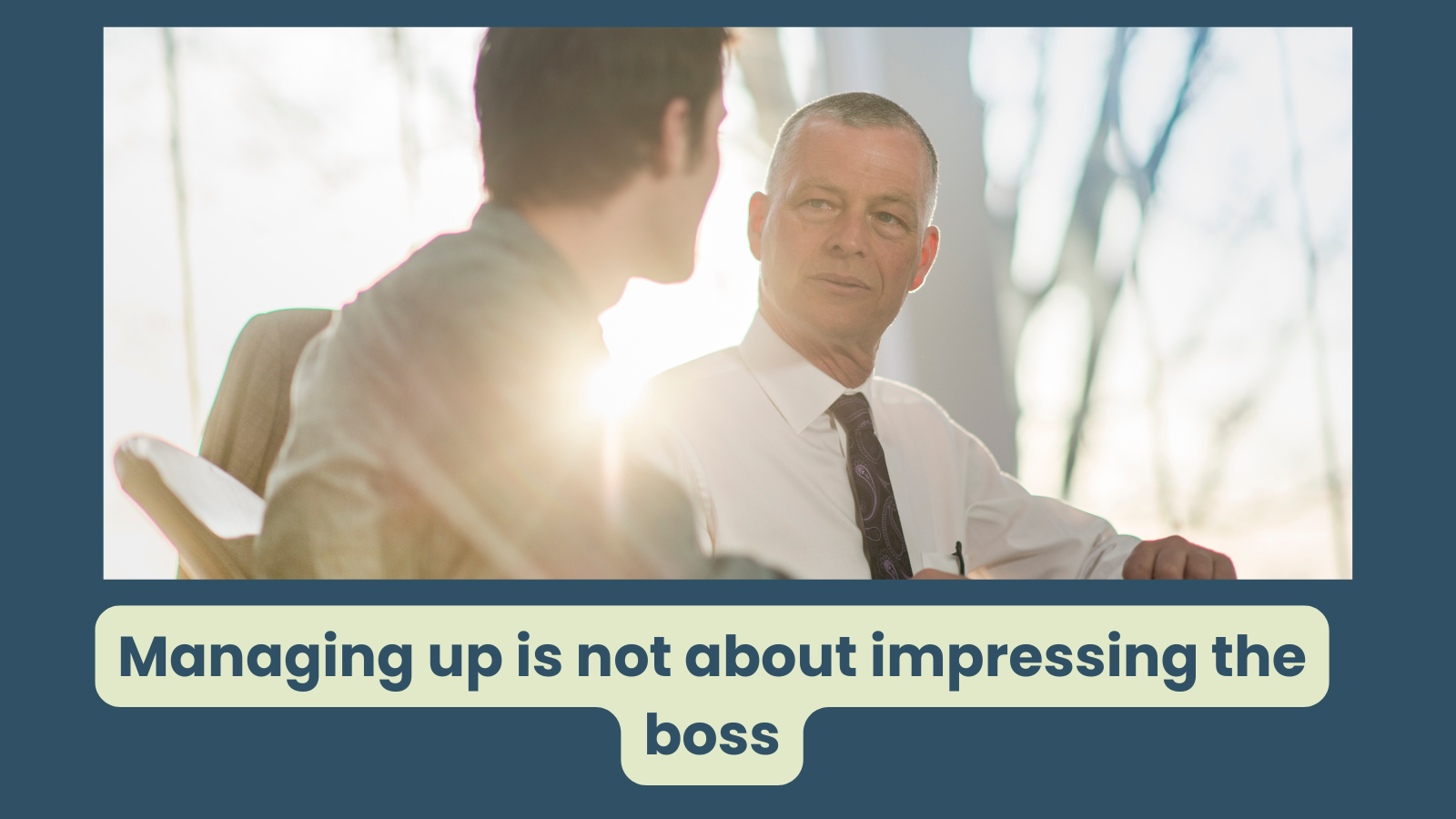a younger employee speaks to his senior manager