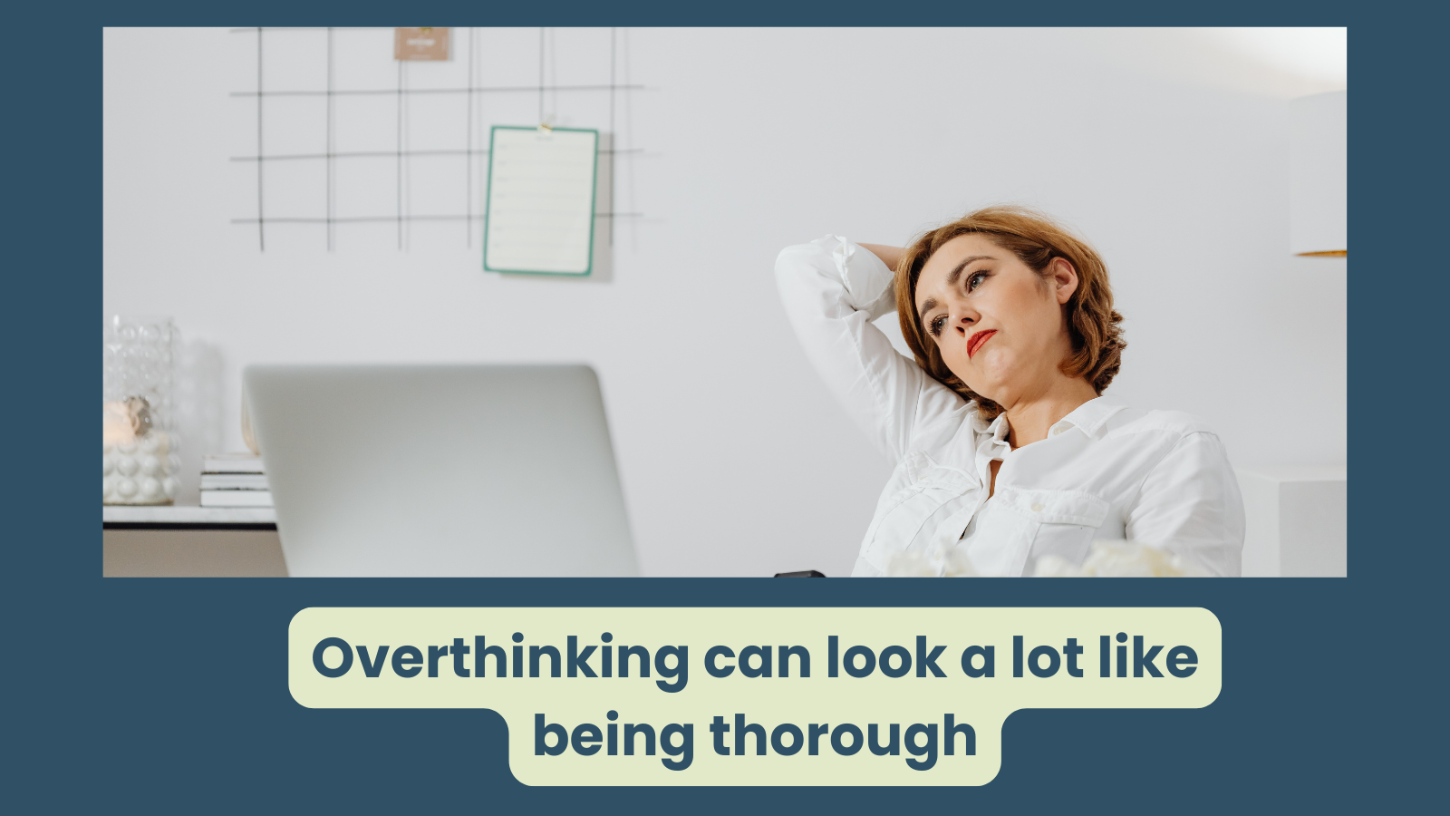 An executive woman is leaning back in front of her lap top, her gaze is distant and she looks to be deep in tought - perhaps she is overthinking it