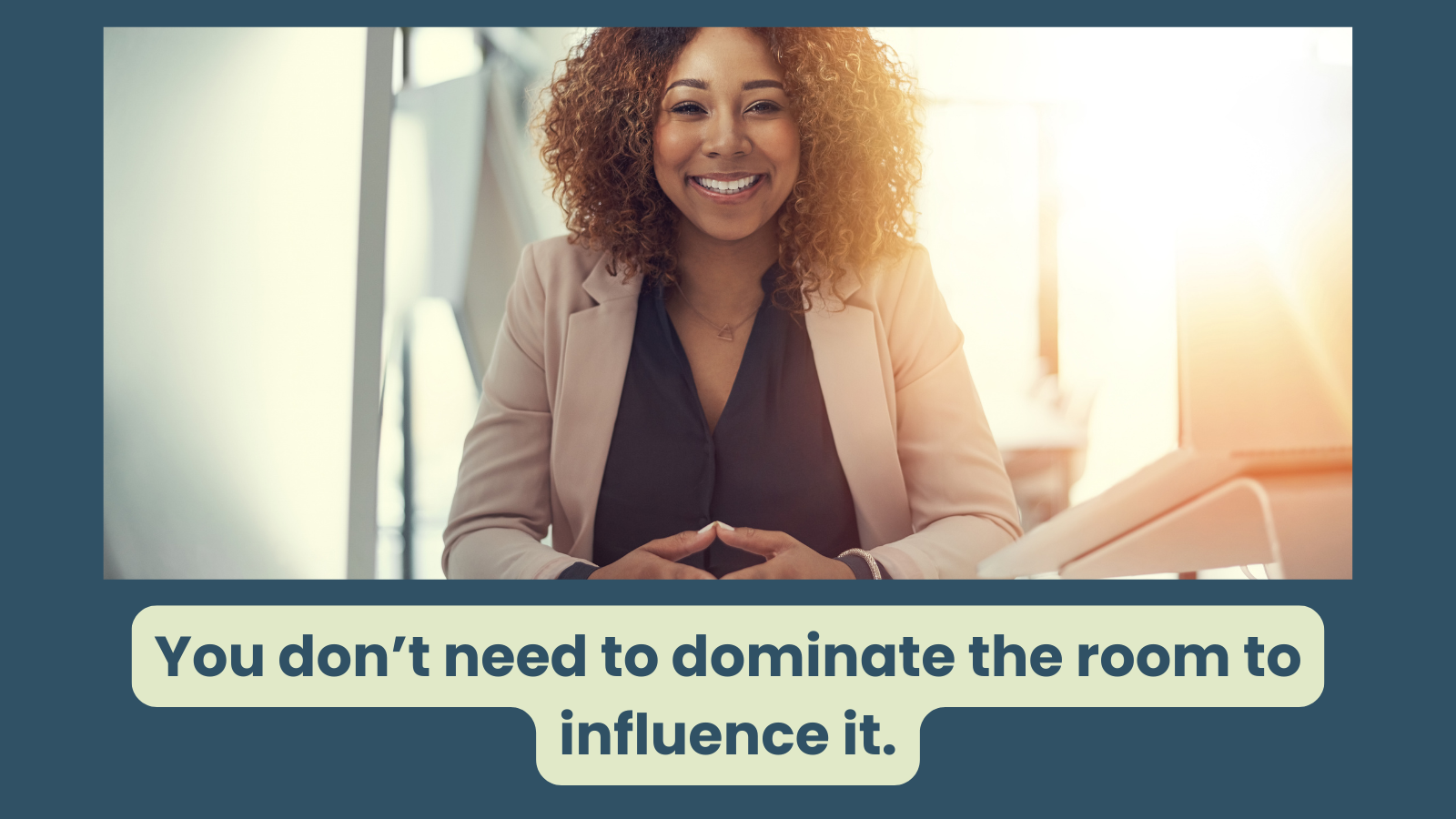 a confident and happy looking women is looking at the camera, she is just being present and is ready to listen