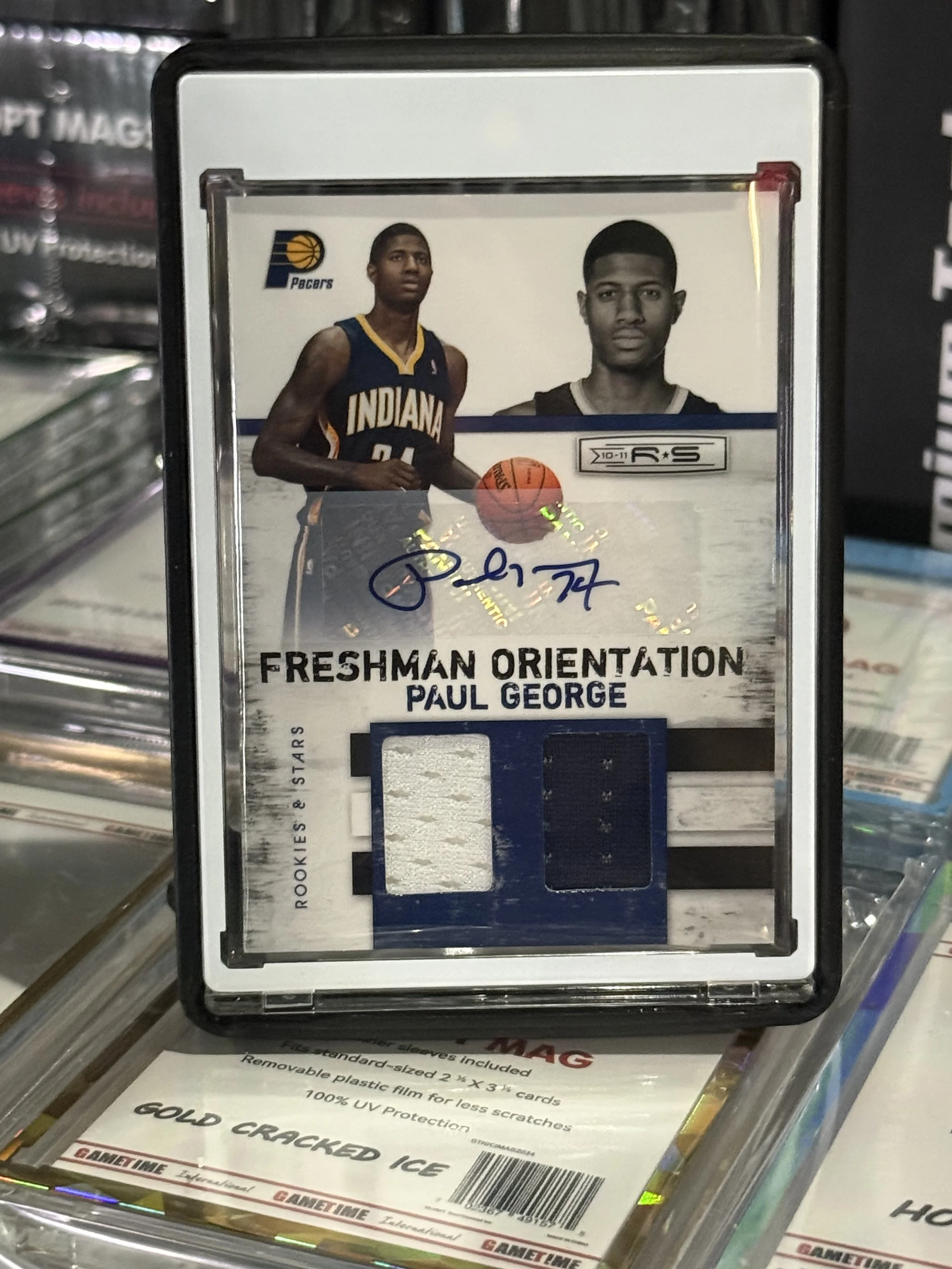 Basketball trading card of Paul George, showing him in Indiana Pacers uniform, with autograph, autograph signature, and two fabric patches with team colors, labeled 'Freshman Orientation'.