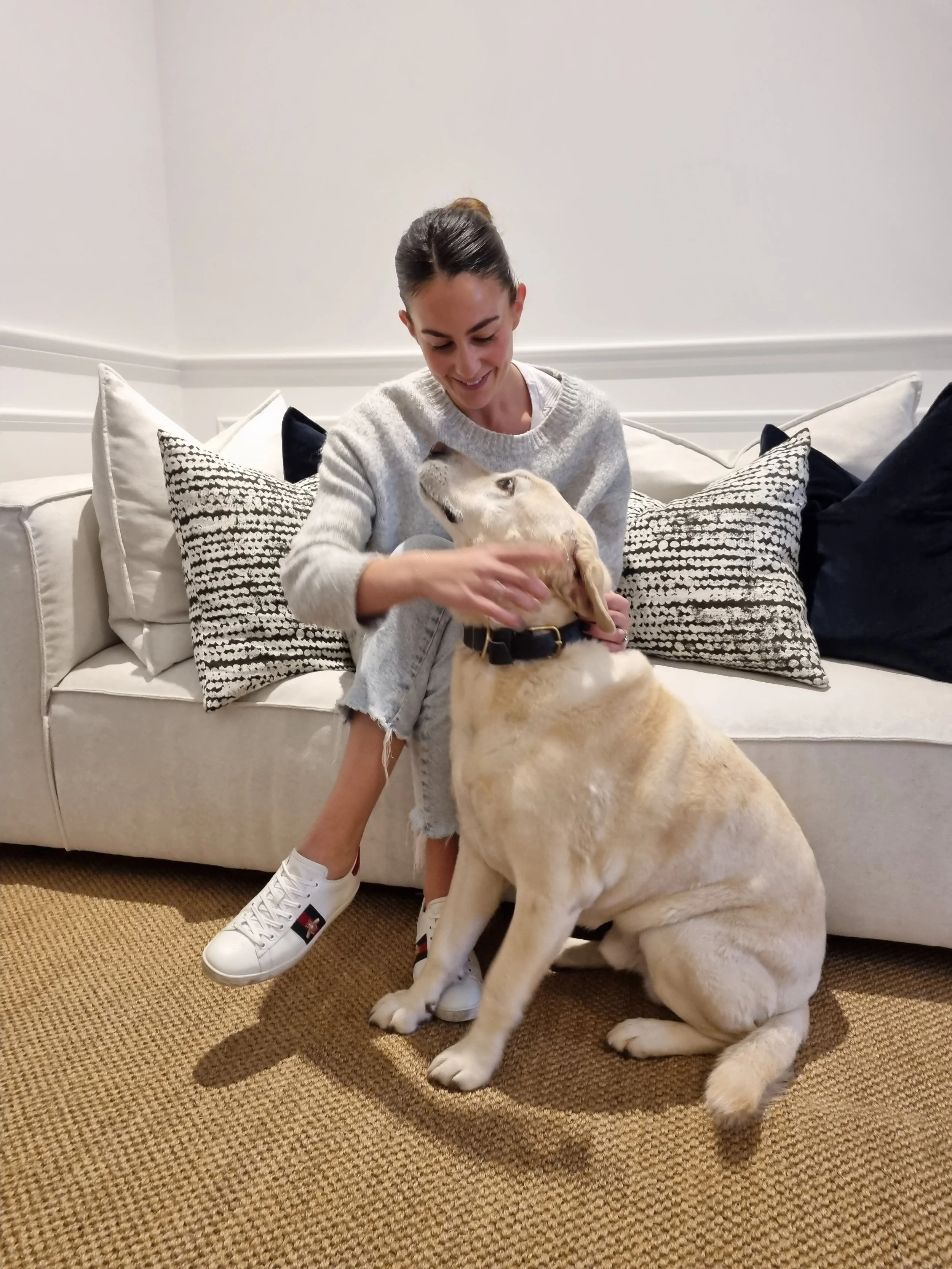 Ellie Walker sitting on Armour Sisal natural flooring