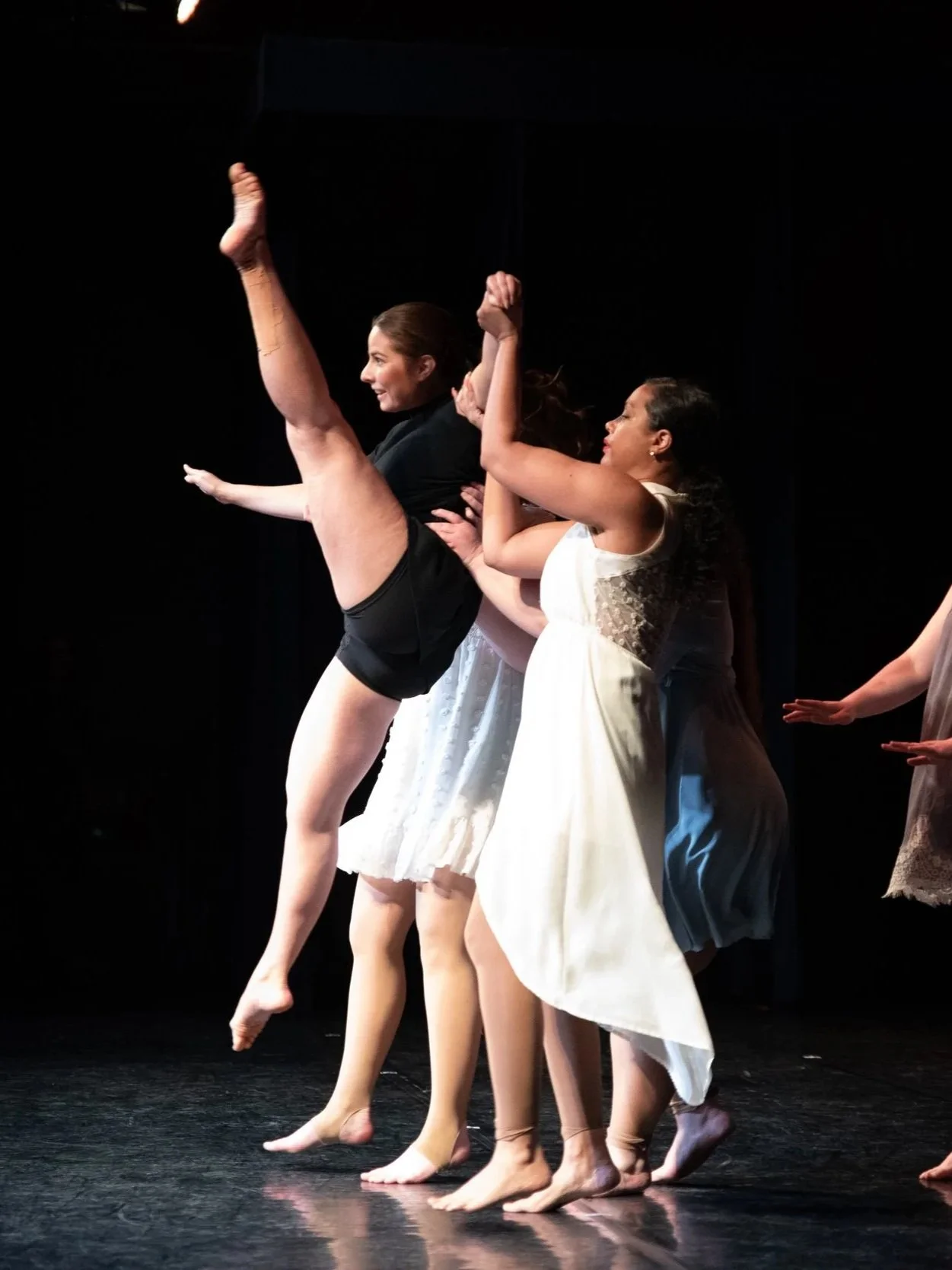 Group of people posing on stage, black and white photo