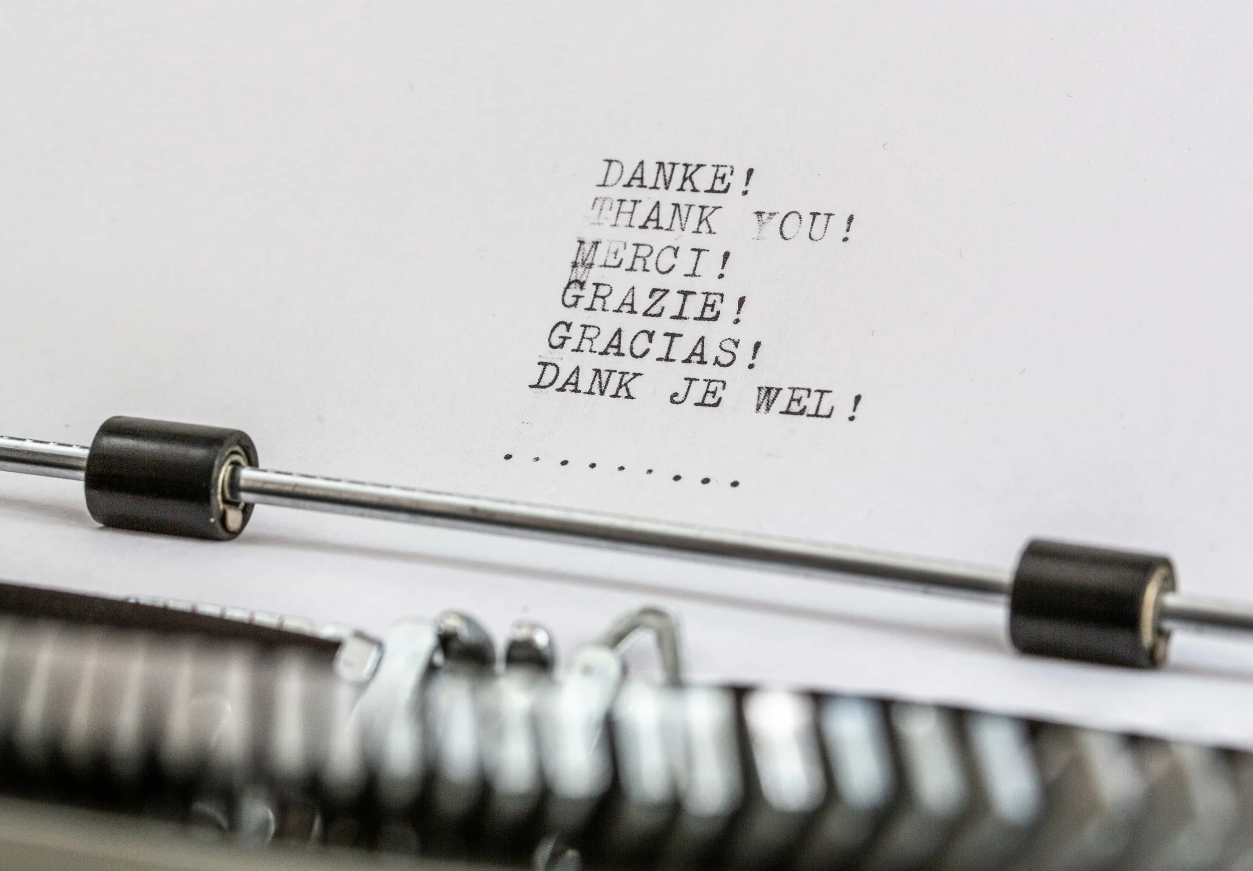 a typewriter showing thank you in different languages