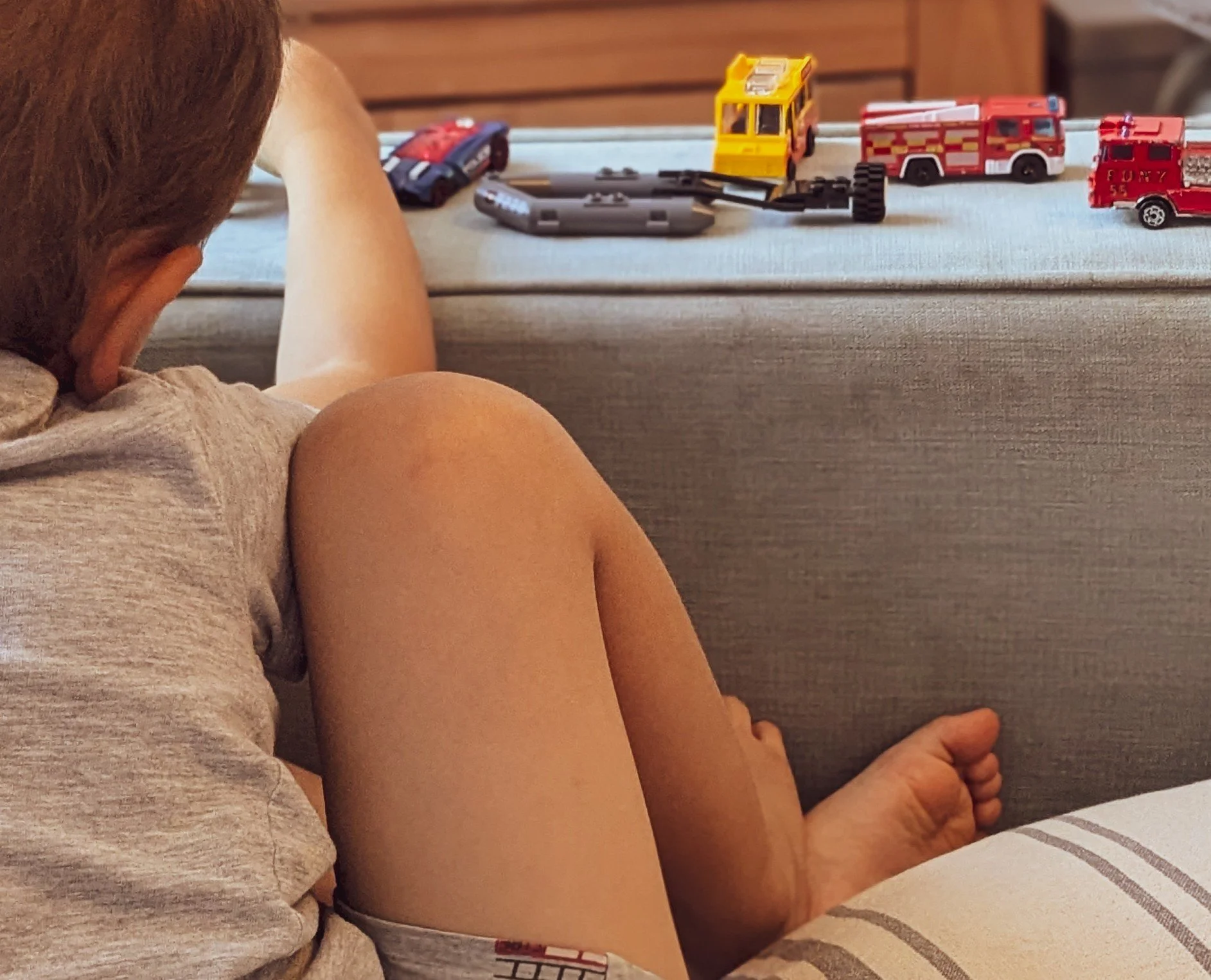 Thick arms of a sofa become a road in play 