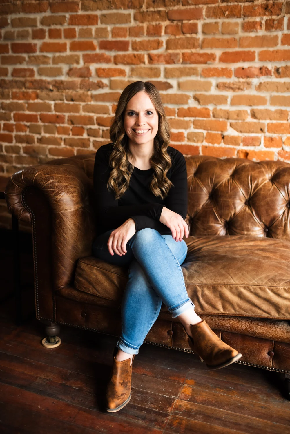 Bonnie Hoewing seated on a leather sofa