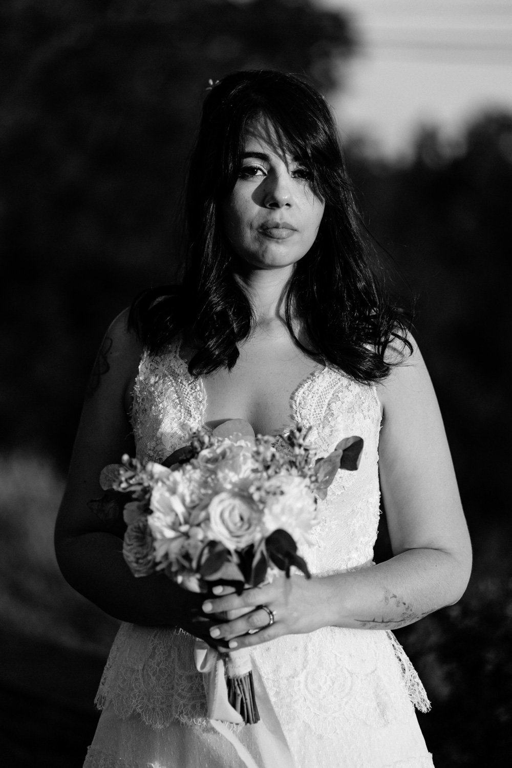 Une femme en robe de mariée, tenant un bouquet.
