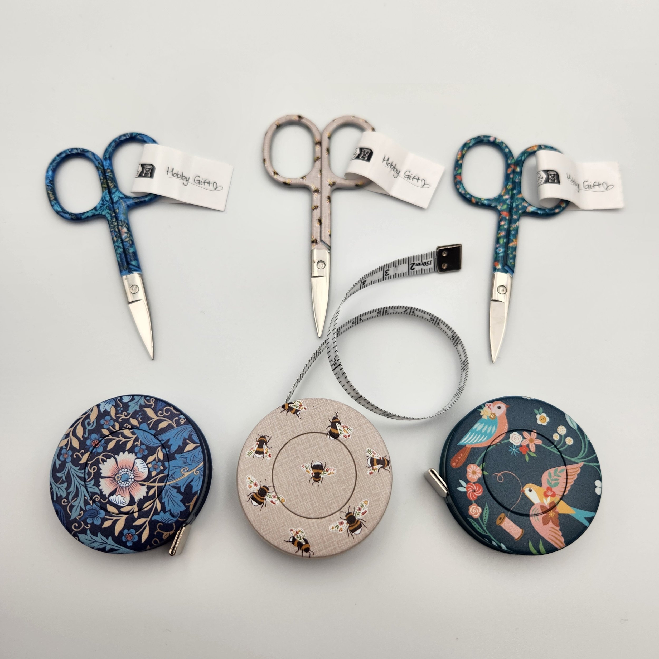 hobby gift retractable tape measure with tape extended shown with matching embroidery scissors