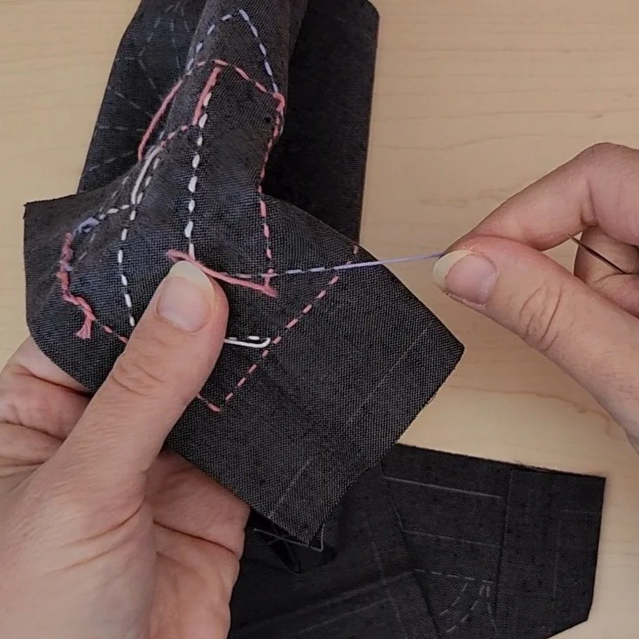 Hand stitching sashiko coaster from the back, pulling thread through to prevent twisted stitches.