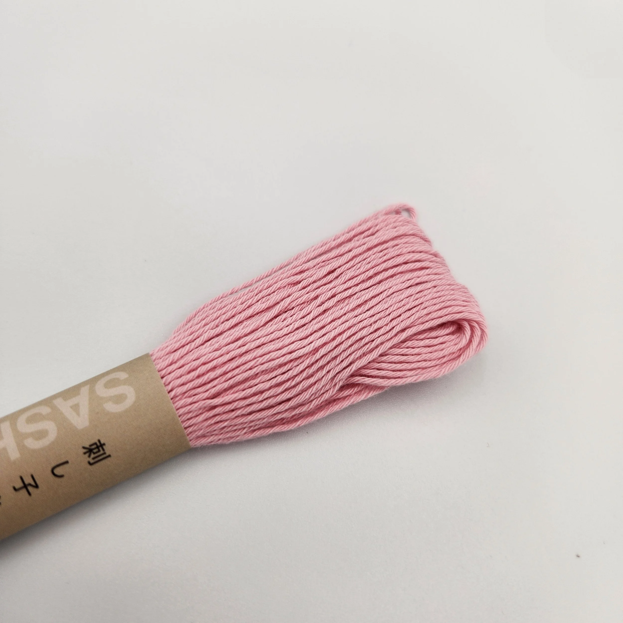 Olympus sashiko thread 20m skein, light pink.
