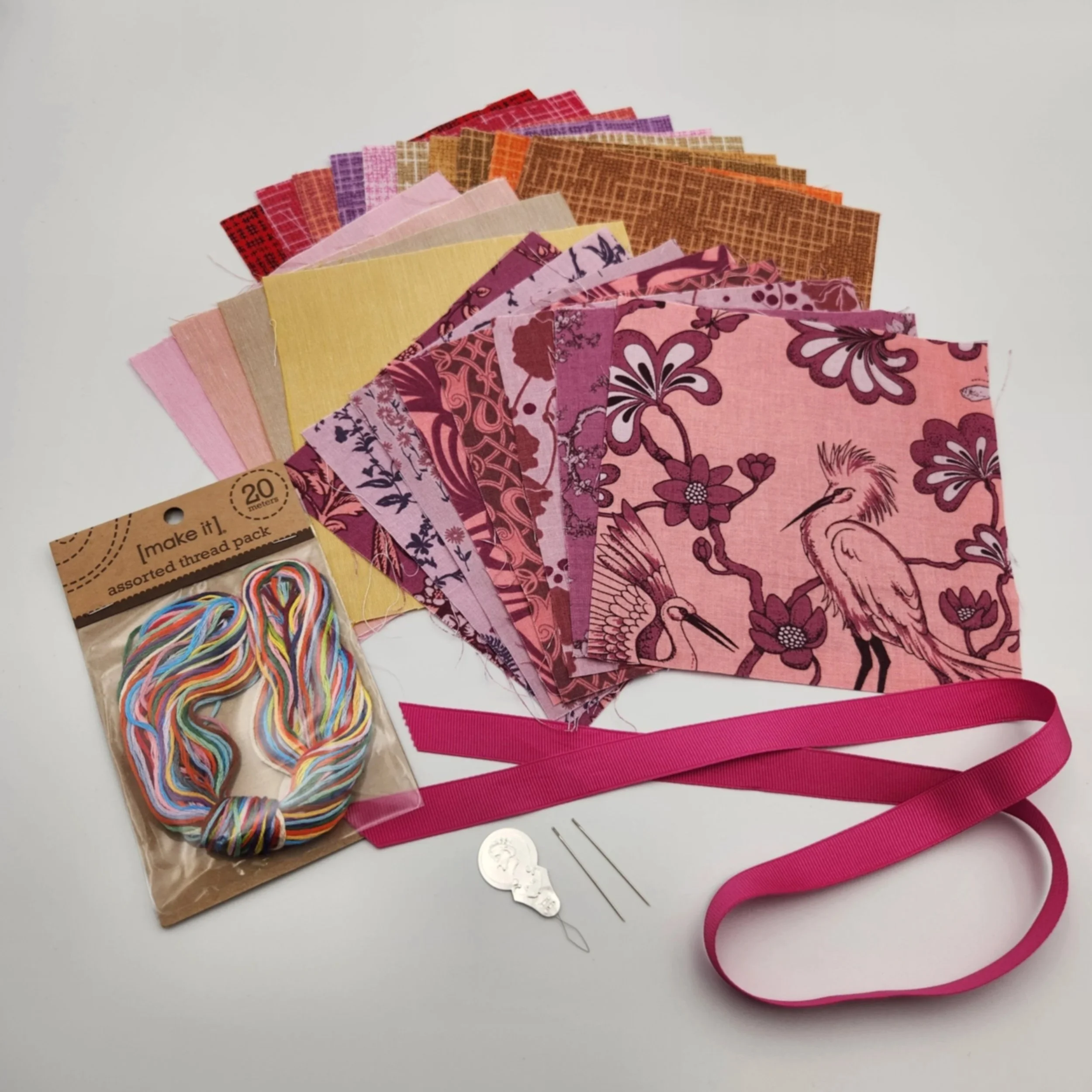 mending patch kit warm colour pack with assorted fabric squares, embroidery thread, ribbon, needles and needle threader