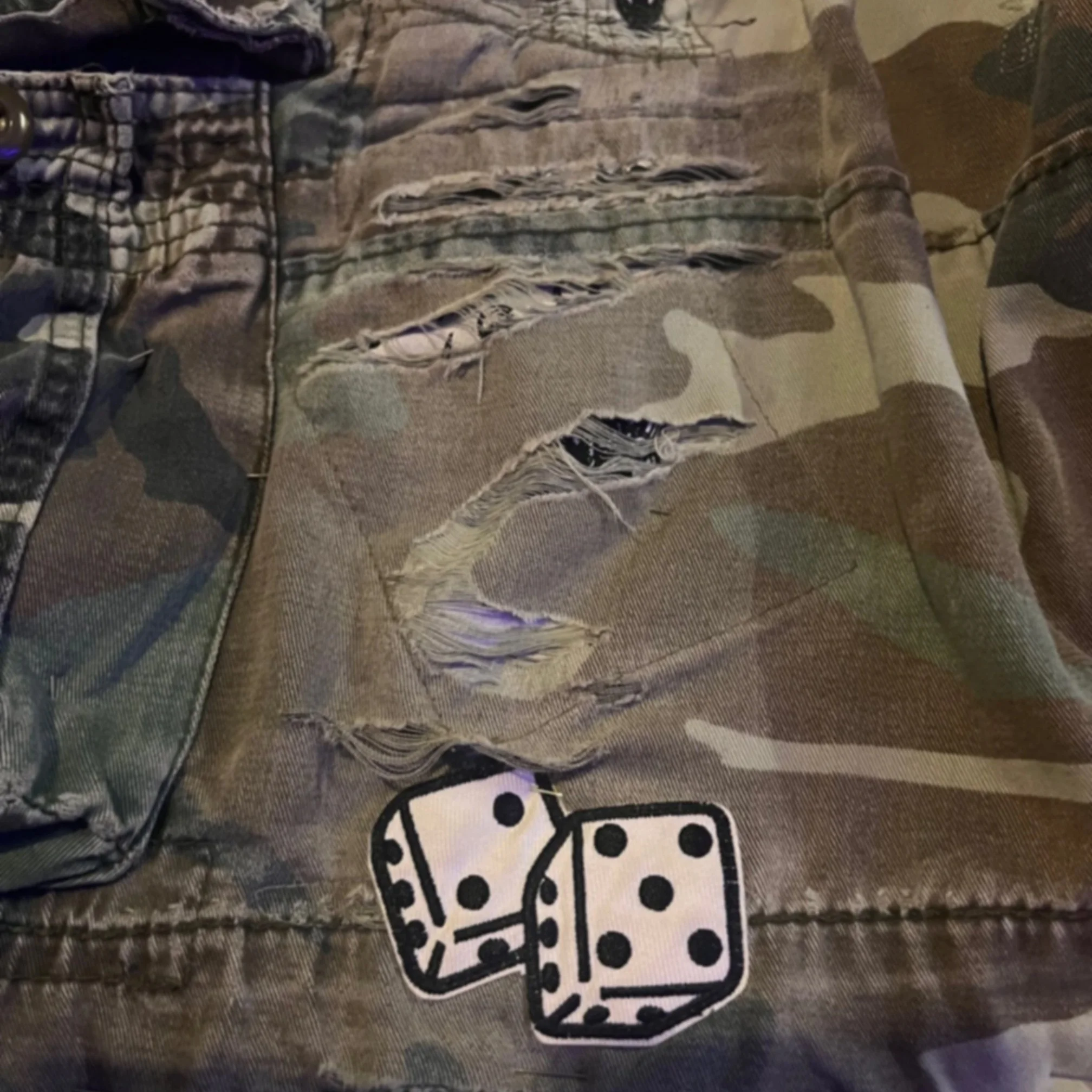 Camo shorts with torn fabric.