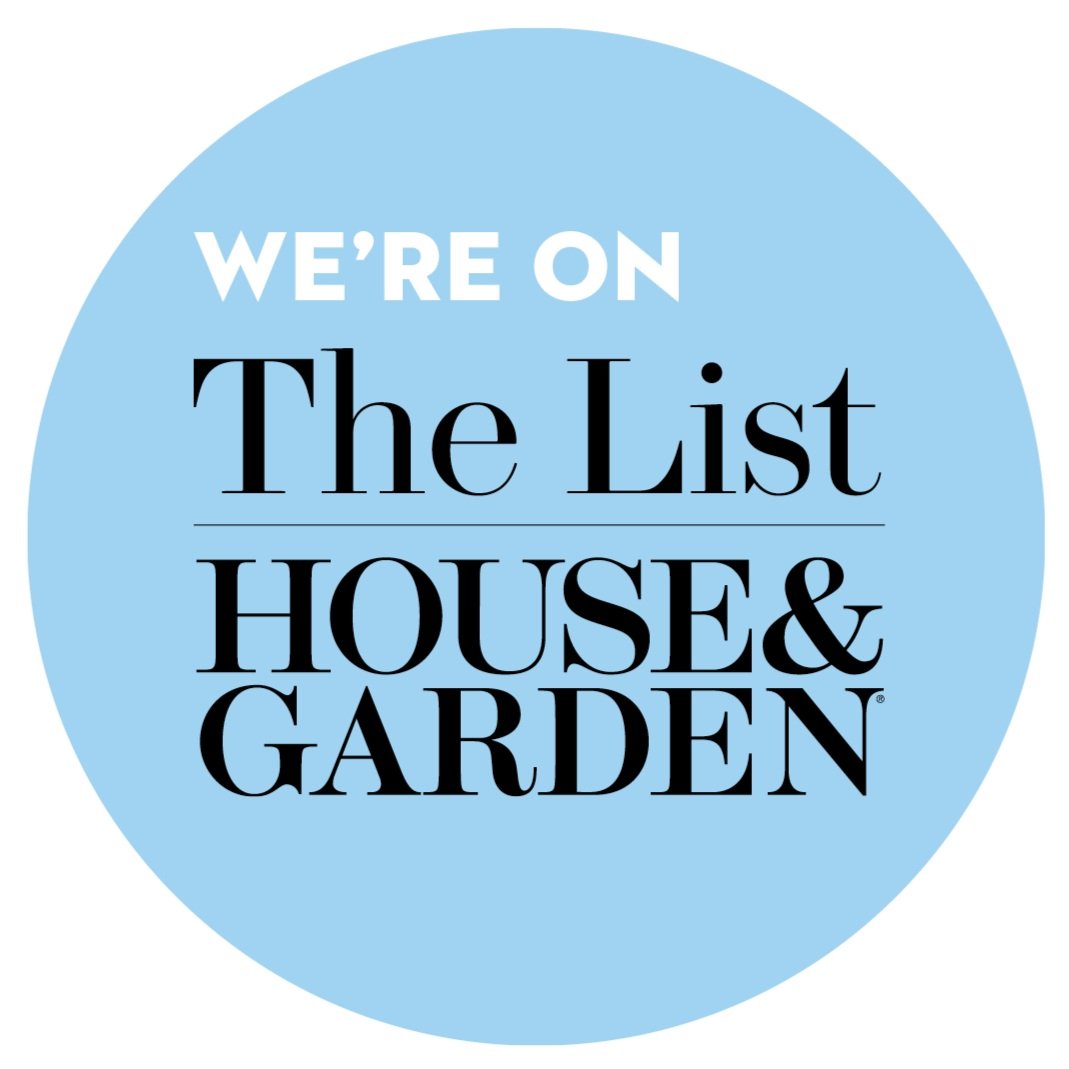 A circular badge with a light blue background and white and black text that reads: "We're on The List House & Garden."