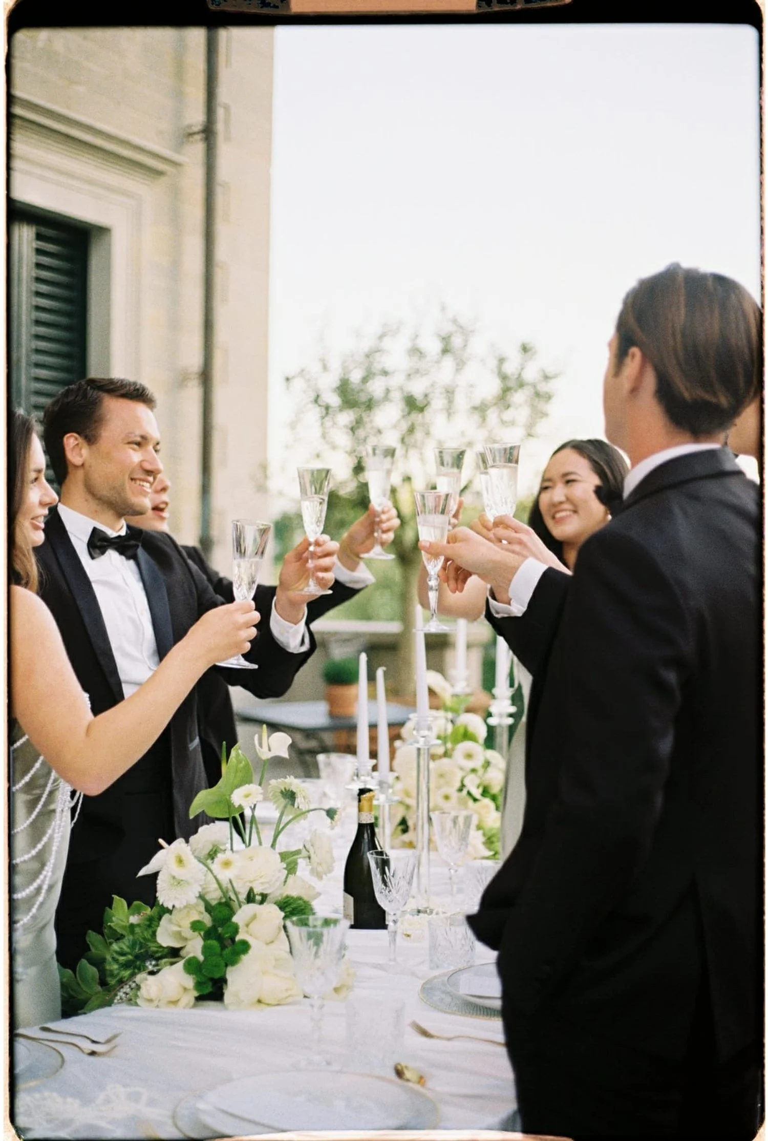 Guests toasting at a wedding in Tuscany on 35mm film