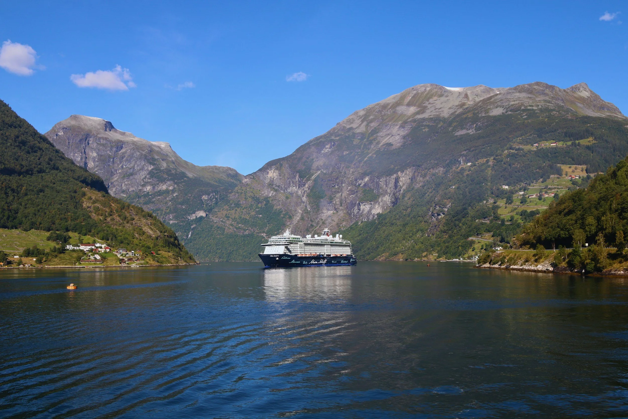 A cruise ship surrounded by mountains