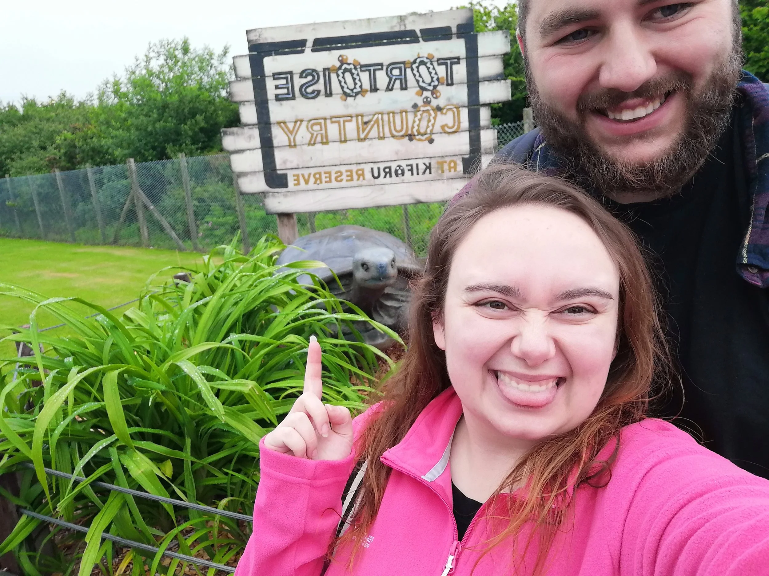 plus size man and woman standing in front of a sign at Folly Farm in Wales