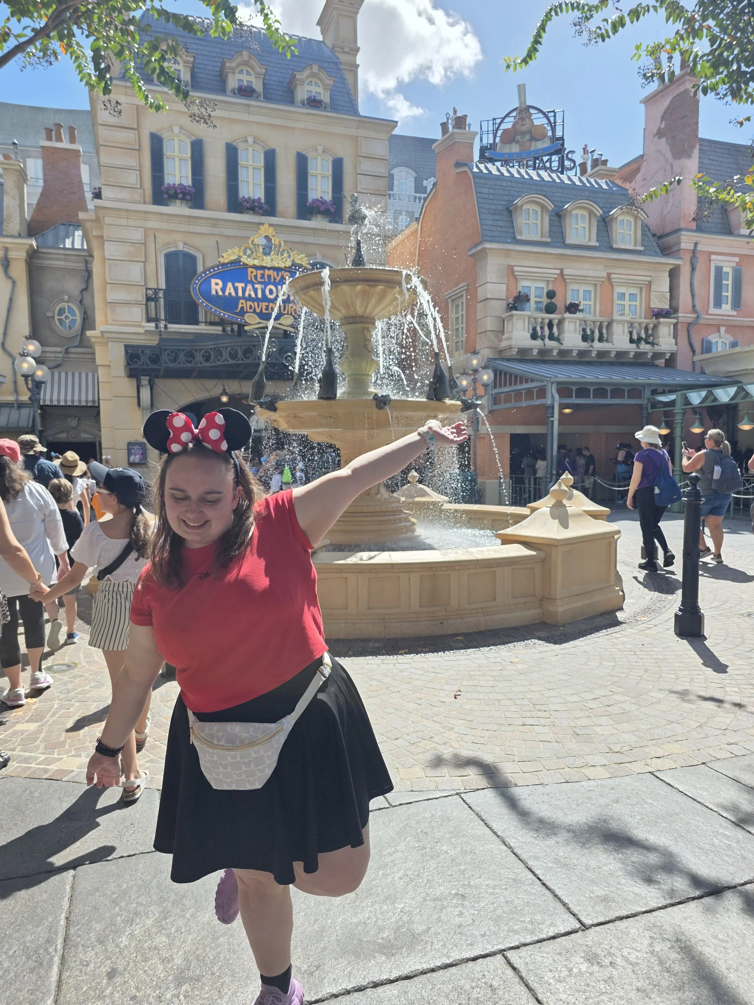 Emily standing in front of Remy's ratatouille adventure.