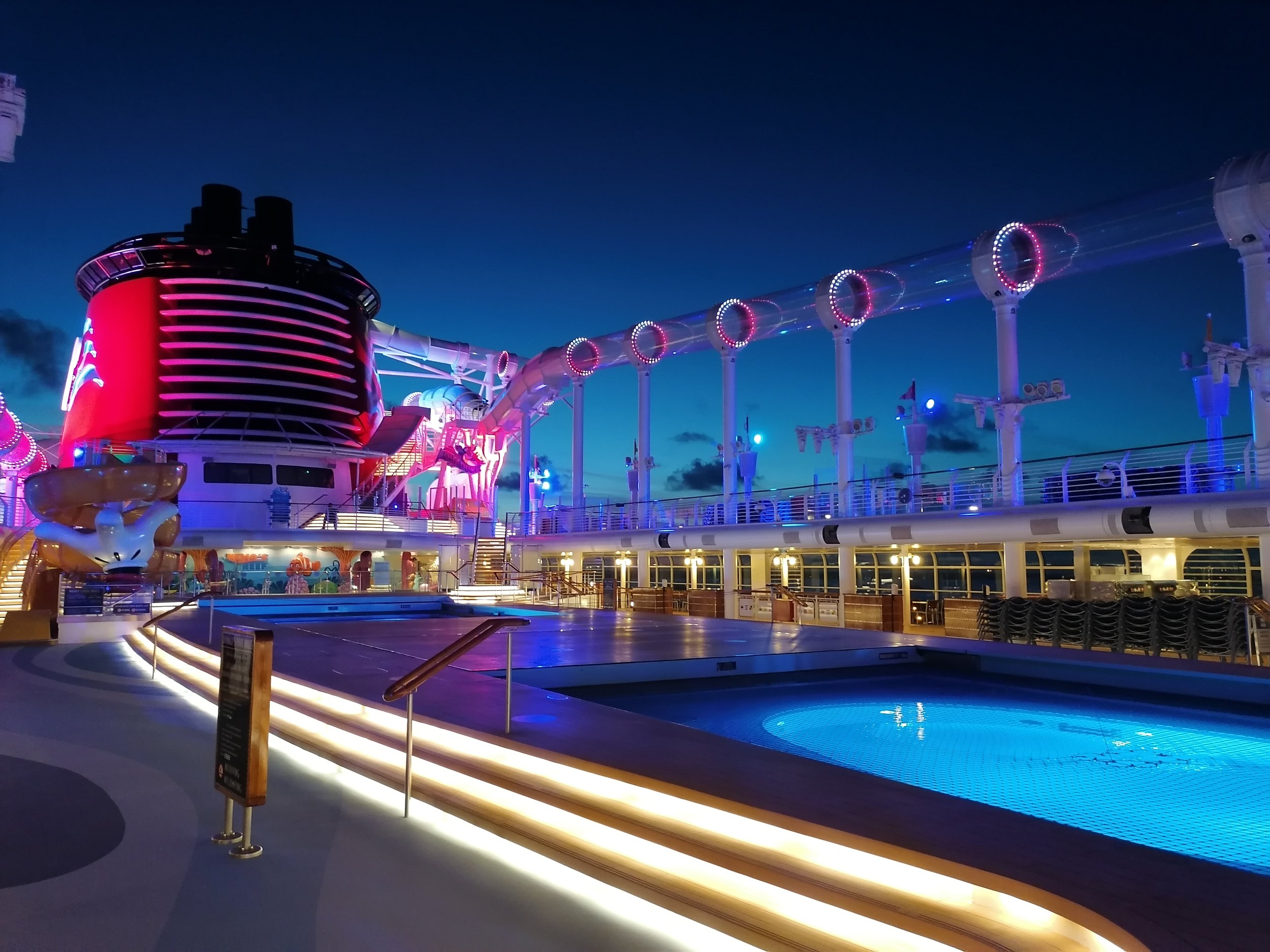 An empty Disney Fantasy pool deck after sunset