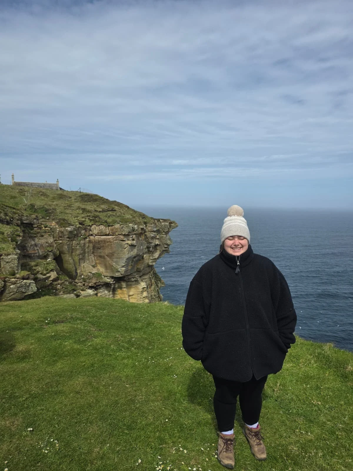 Emily standing near the cliff edge at Dunnet Head
