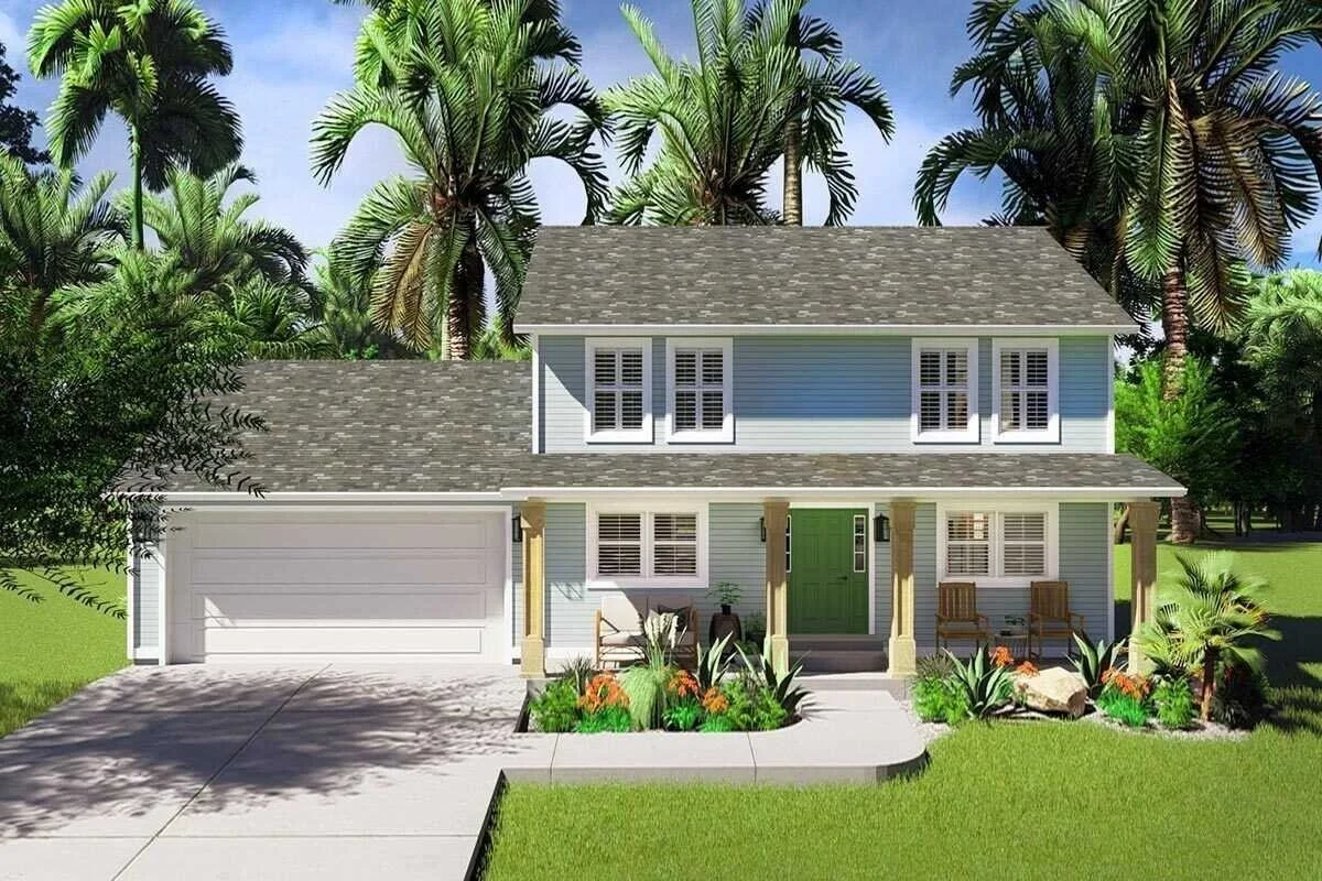 A two-story blue house with a gray shingle roof, white window shutters, and a green front door. The front yard has a landscaped garden with various plants and a concrete pathway leading to the porch with two wooden chairs. In the background, tall pal