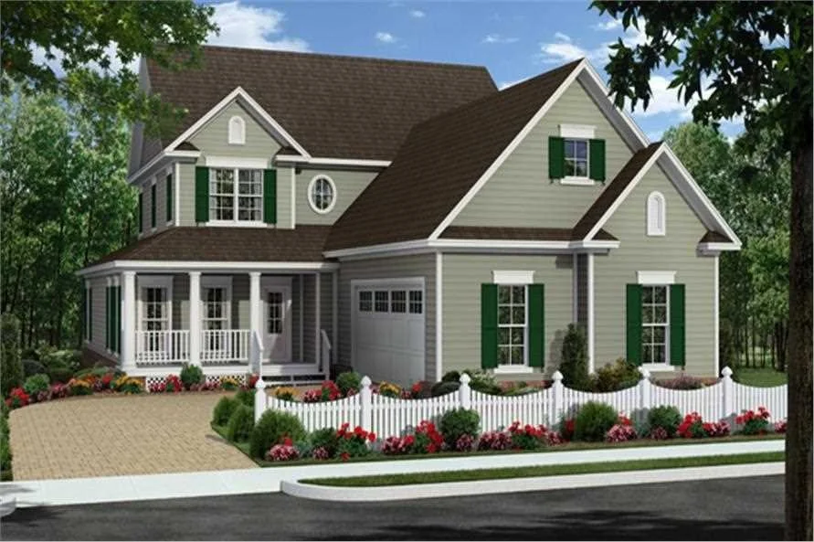 A two-story house with gray siding, green shutters, and a brown roof, surrounded by a landscaped yard with flowers and a white picket fence.