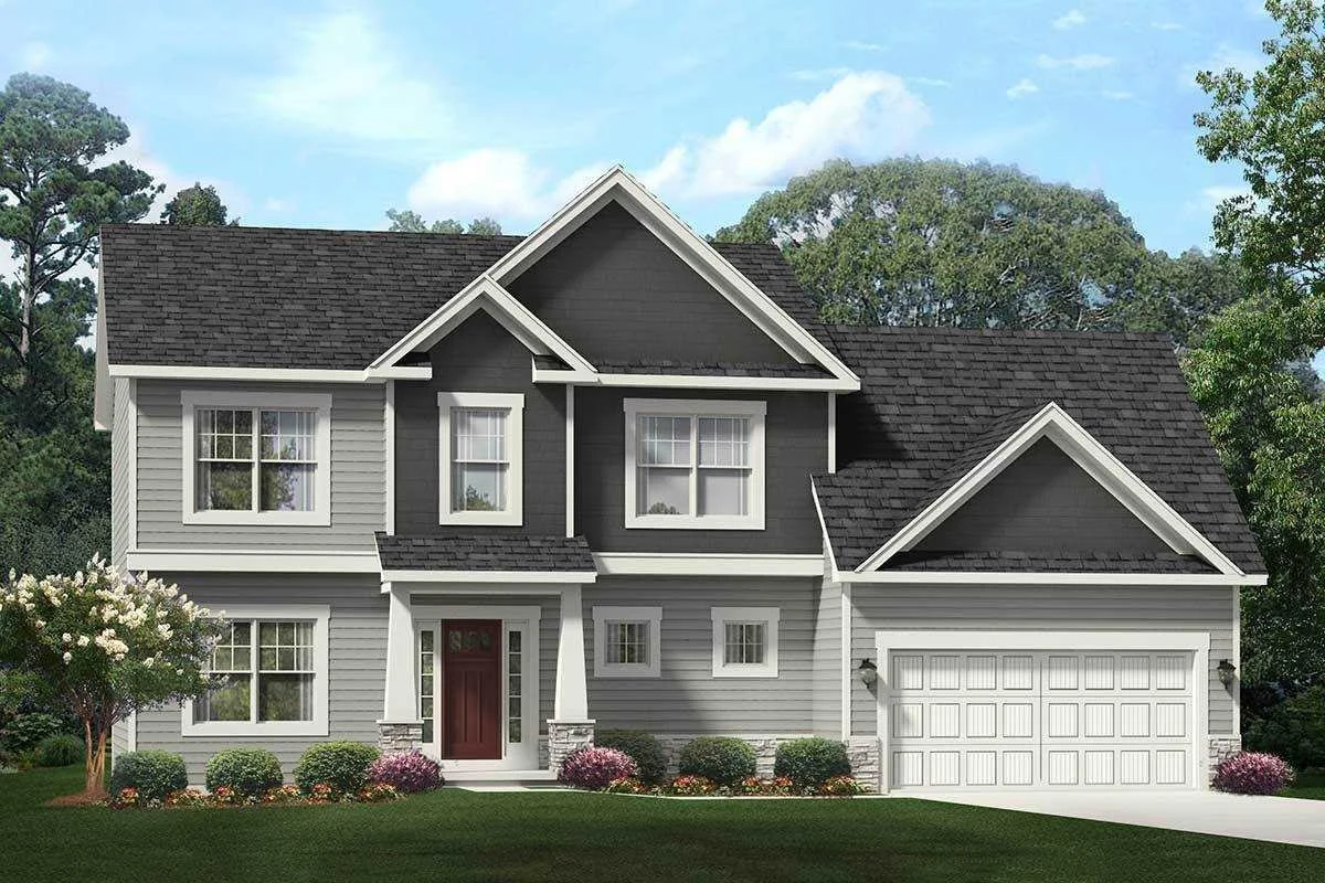 A two-story house with gray siding, black shingles, white trim, a front porch with a red door, and an attached garage, surrounded by well-maintained landscaping and trees.