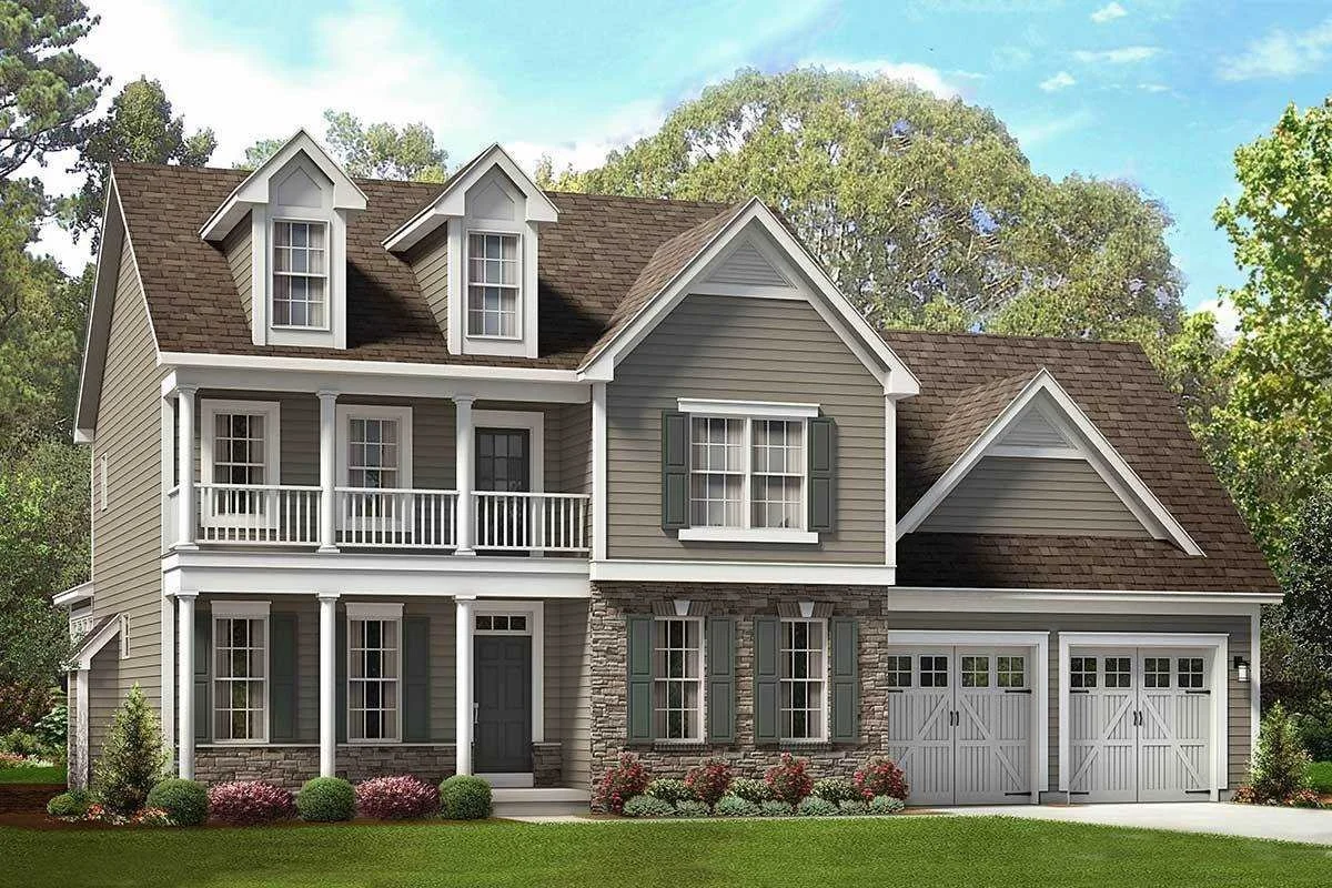 A two-story house with gray siding, white trim, green shutters, a front porch, and a two-car garage, surrounded by trees and a well-maintained lawn.