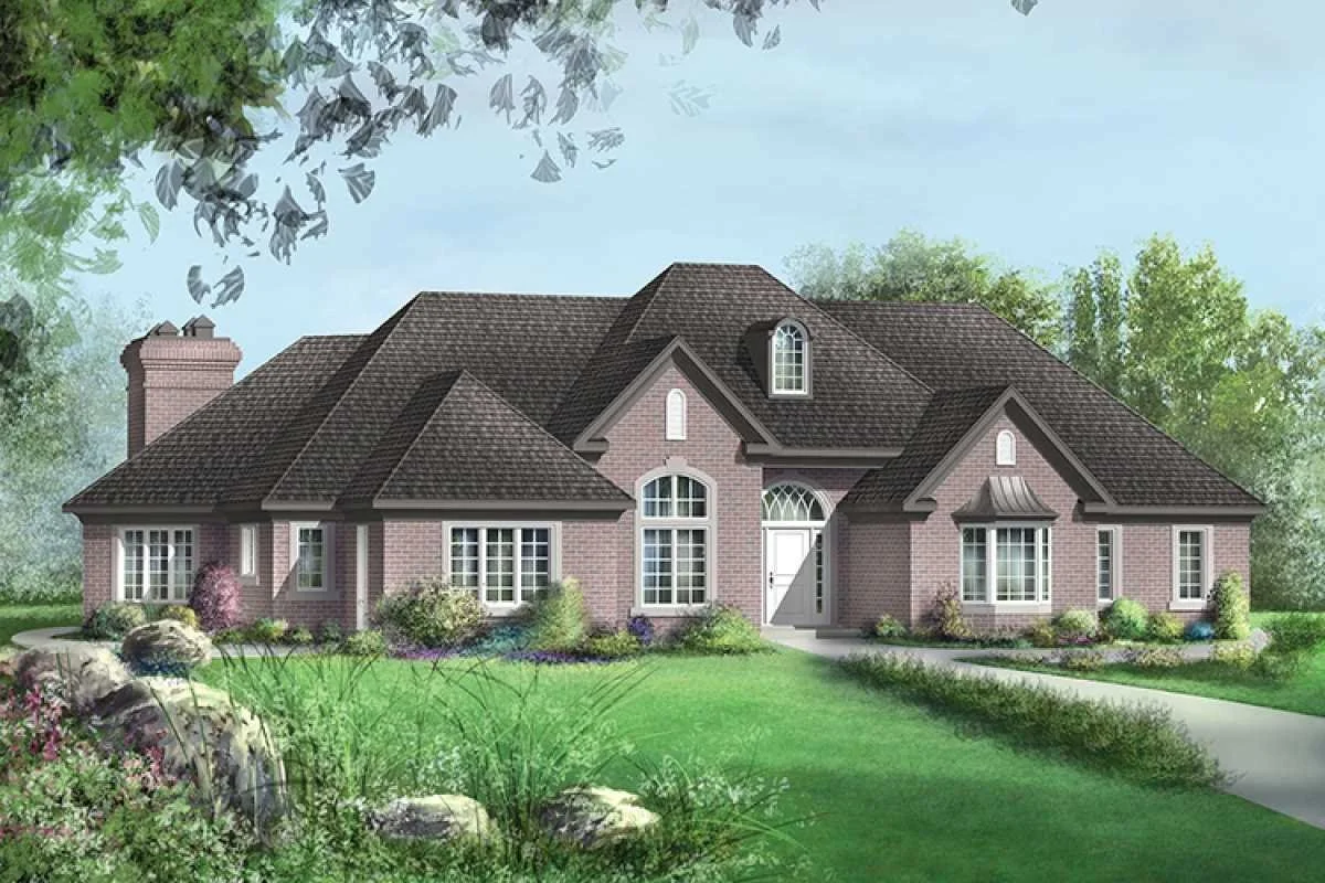 A large, pink brick house with a brown shingled roof, multiple windows, and a white front door on a green lawn with landscaping and trees in the background.