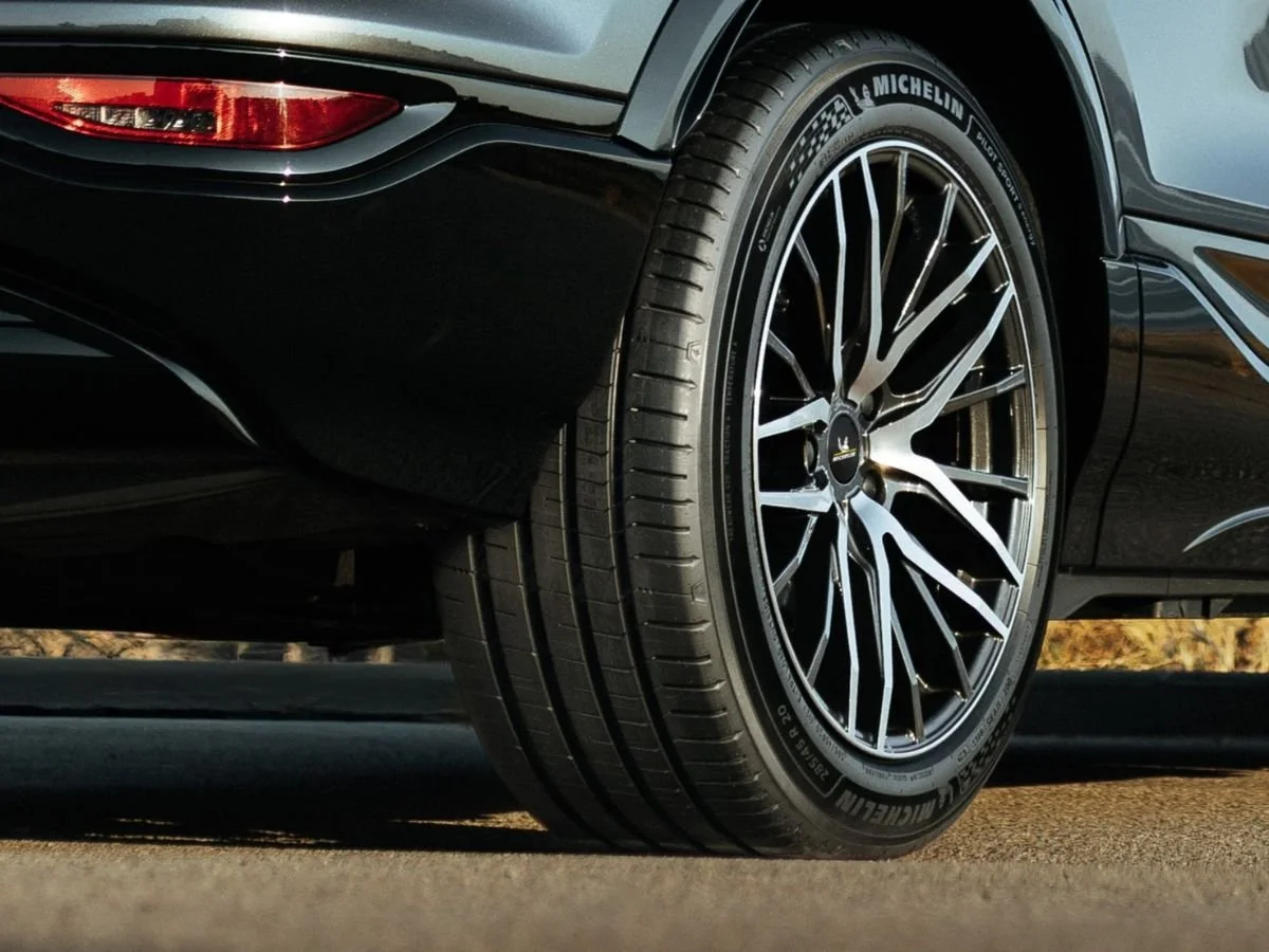 Michelin Pilot Sport tire with Acoustic foam technology on a black performance wheel, showing tread detail.