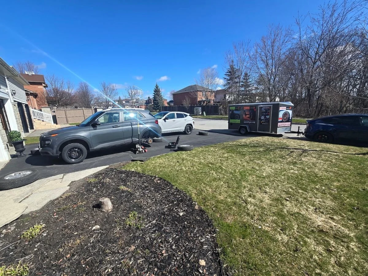 Providing mobile tire service in a Bowmanville driveway, seasonal tire change.